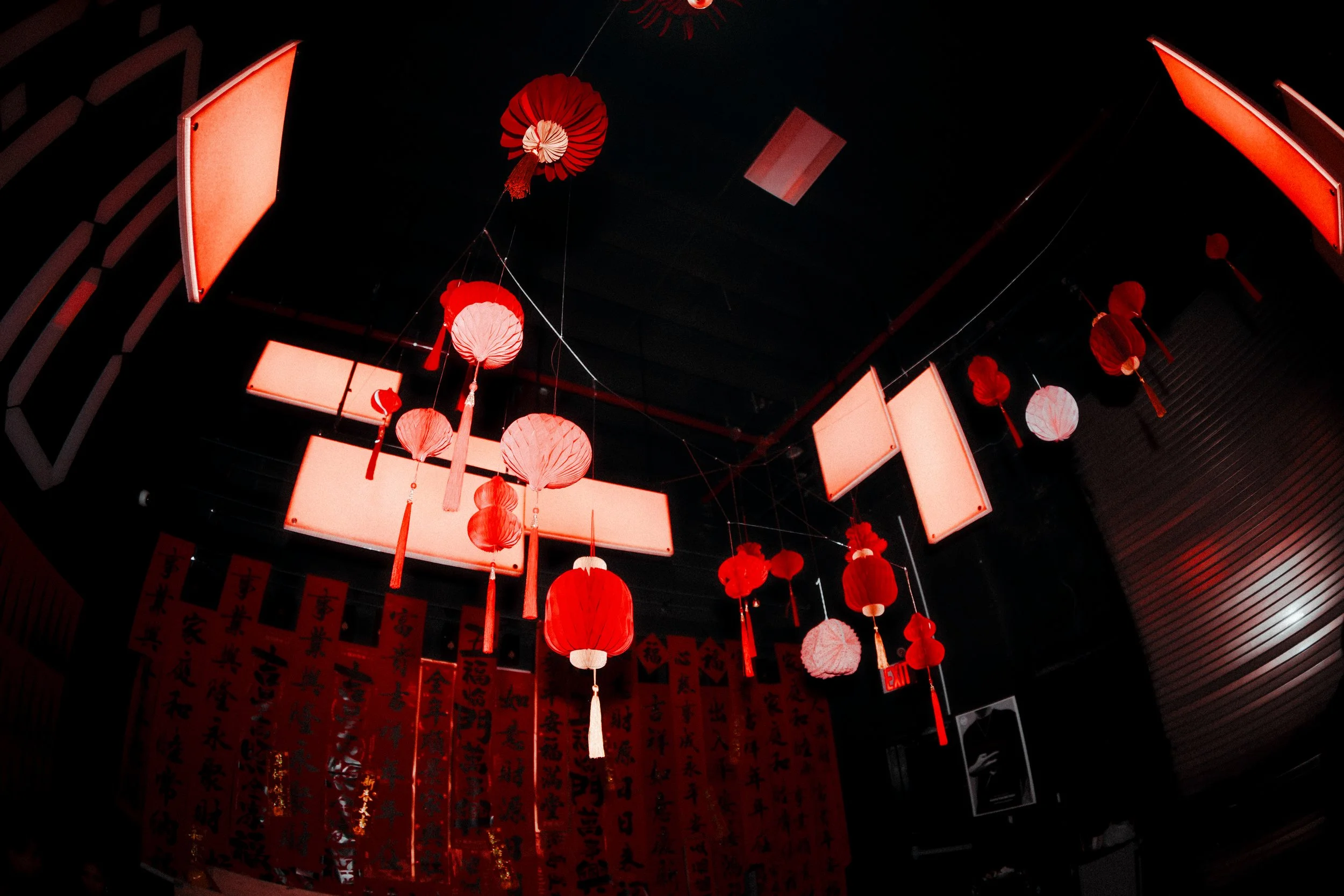 Chinese lanterns hanging from the ceiling, illuminated at the experiential production agency ANG Concept's Lunar New Year Party.