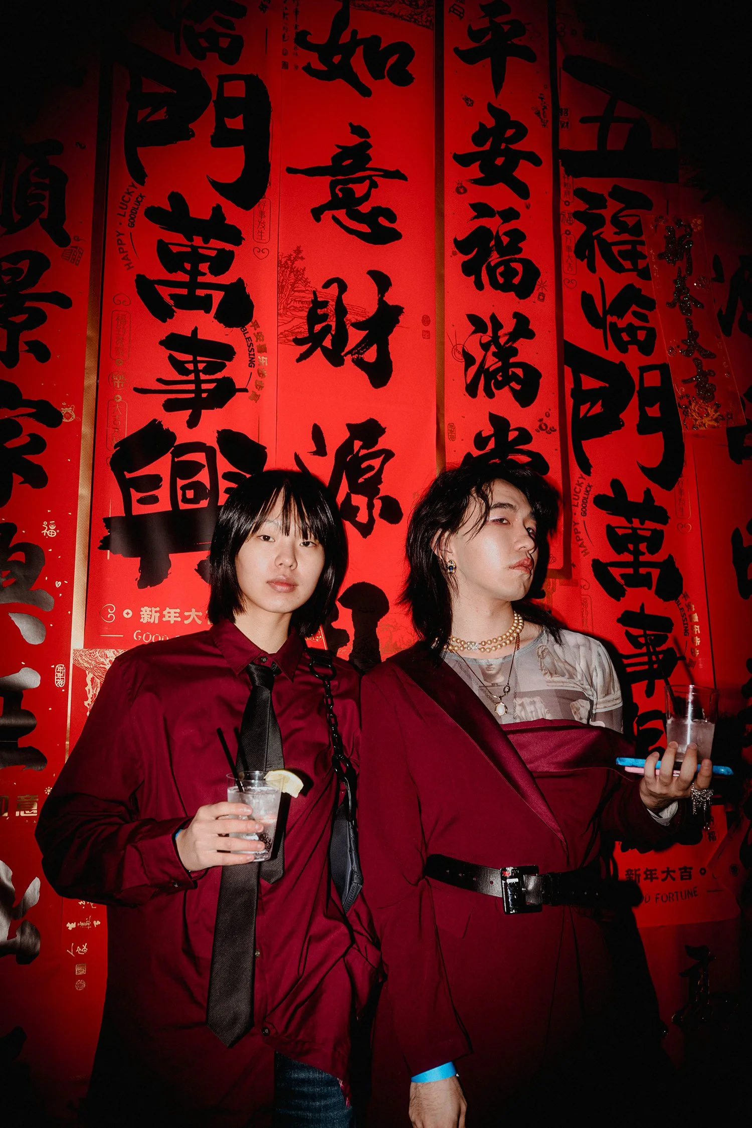 Two VIPs in front of the Chinese calligraphy scroll decorations at event production agency ANG Concept's Lunar New Year Party.