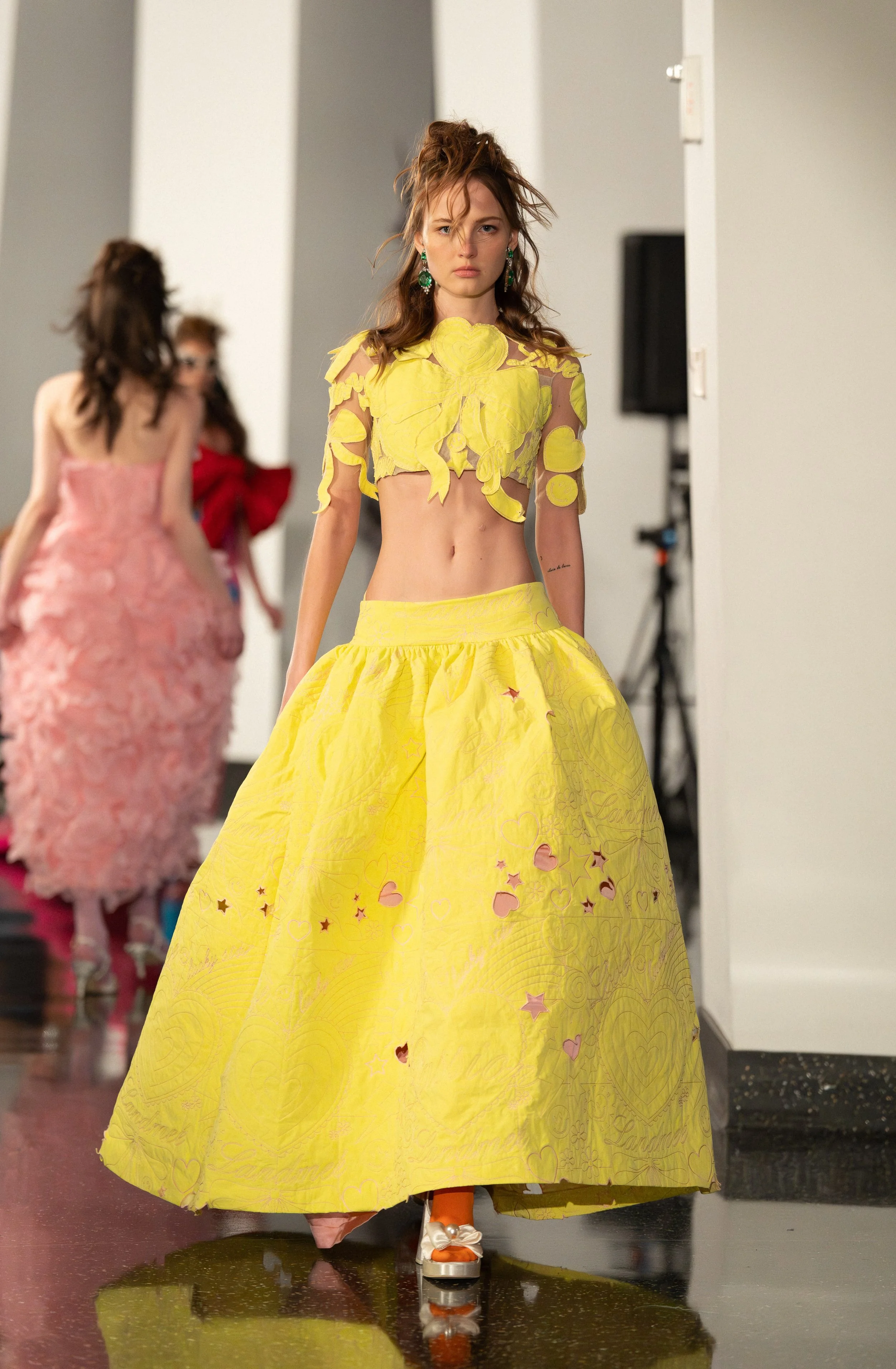A Landmeé model walking down the runway of "Up to the Sky" Bangkok designer fashion show by experiential production agency ANG Concept during NYFW at One World Observatory.