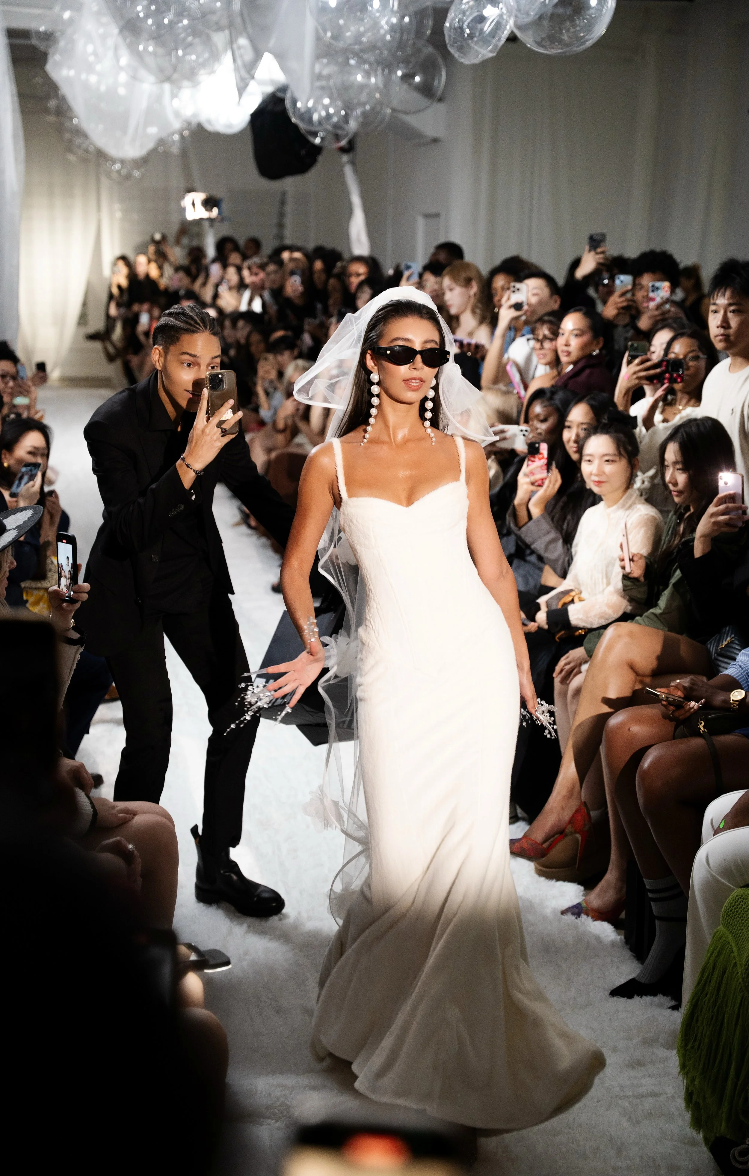 A model in a bridal-inspired look, posting for NYFW SS26 EASTEAM "Rebel Heiress" show by experiential production agency ANG Concept.