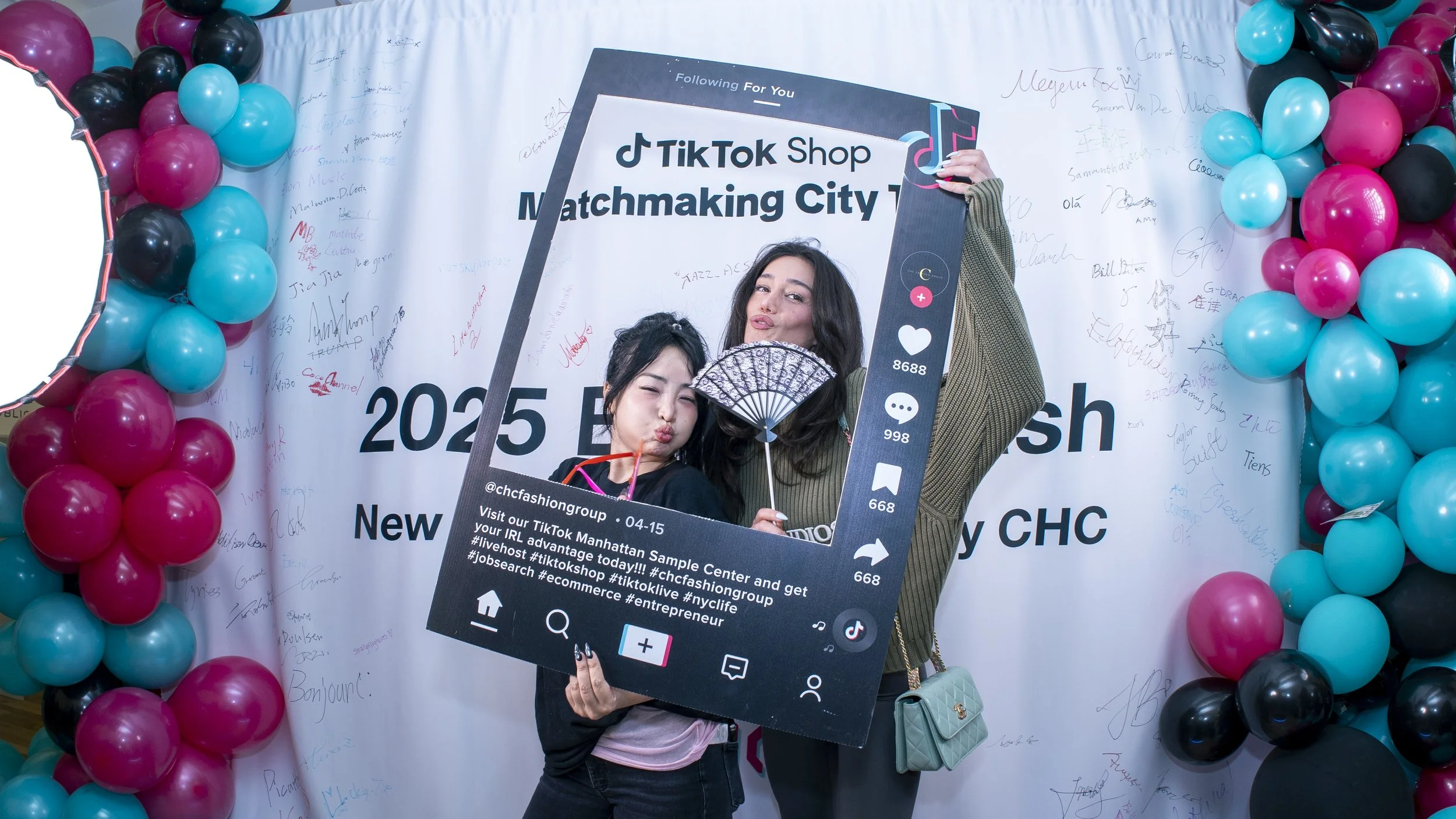 Two creators holding a large TikTok-themed photo frame at a photocall of TikTok Shop Matchmaking City Tour 2025, a three-weekend activation by experiential production agency ANG Concept in New York.