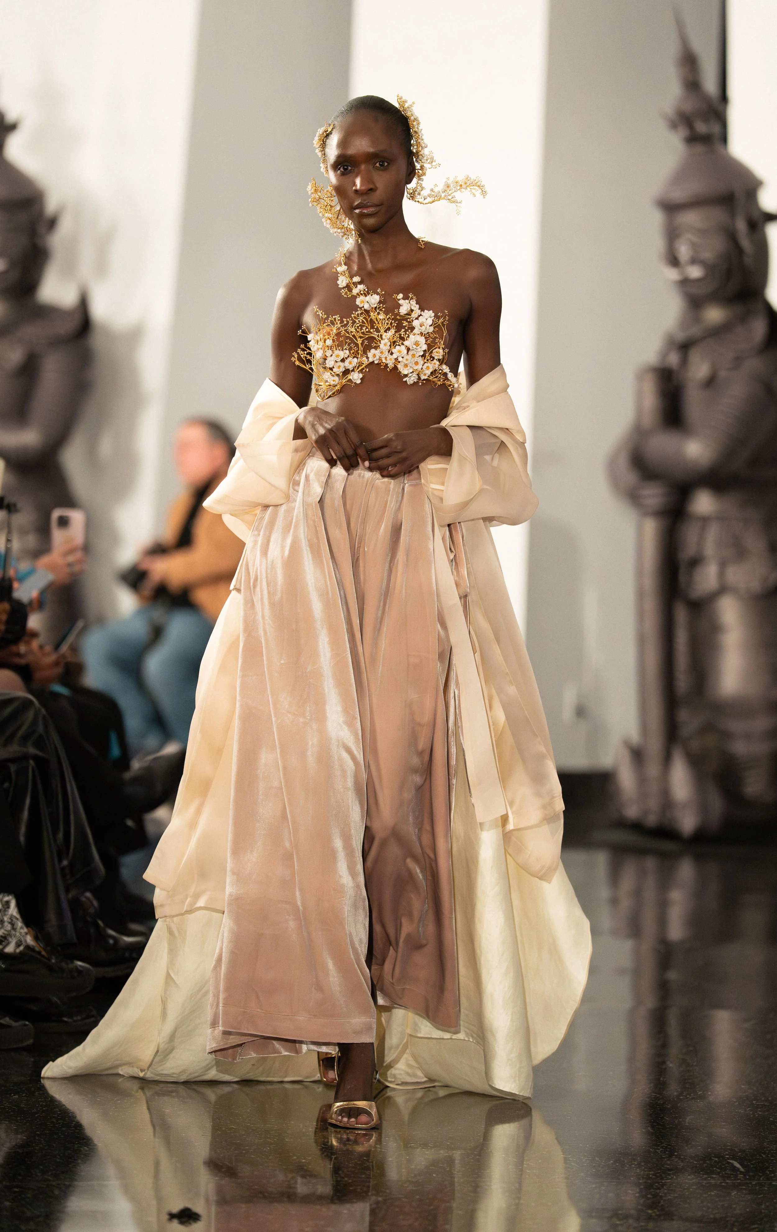 A SARRAN model walking down the runway of "Up to the Sky" Bangkok designer fashion show by experiential production agency ANG Concept during NYFW at One World Observatory.