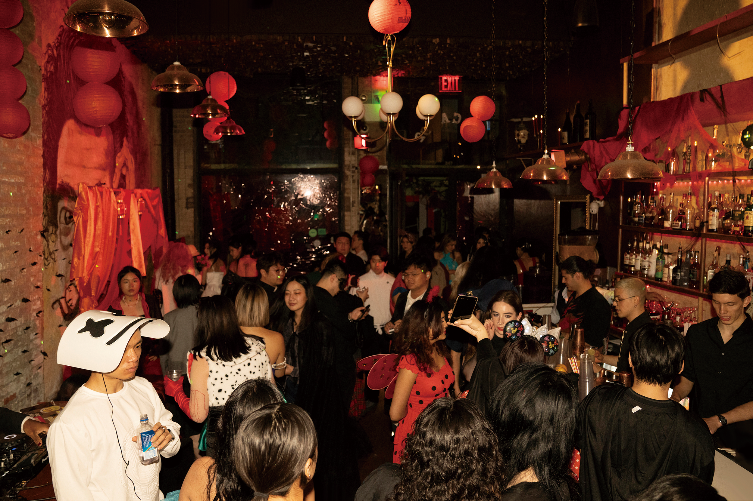 Fashion crowd of Halloween party Madame Rouge with people socializing in SoHo, New York.