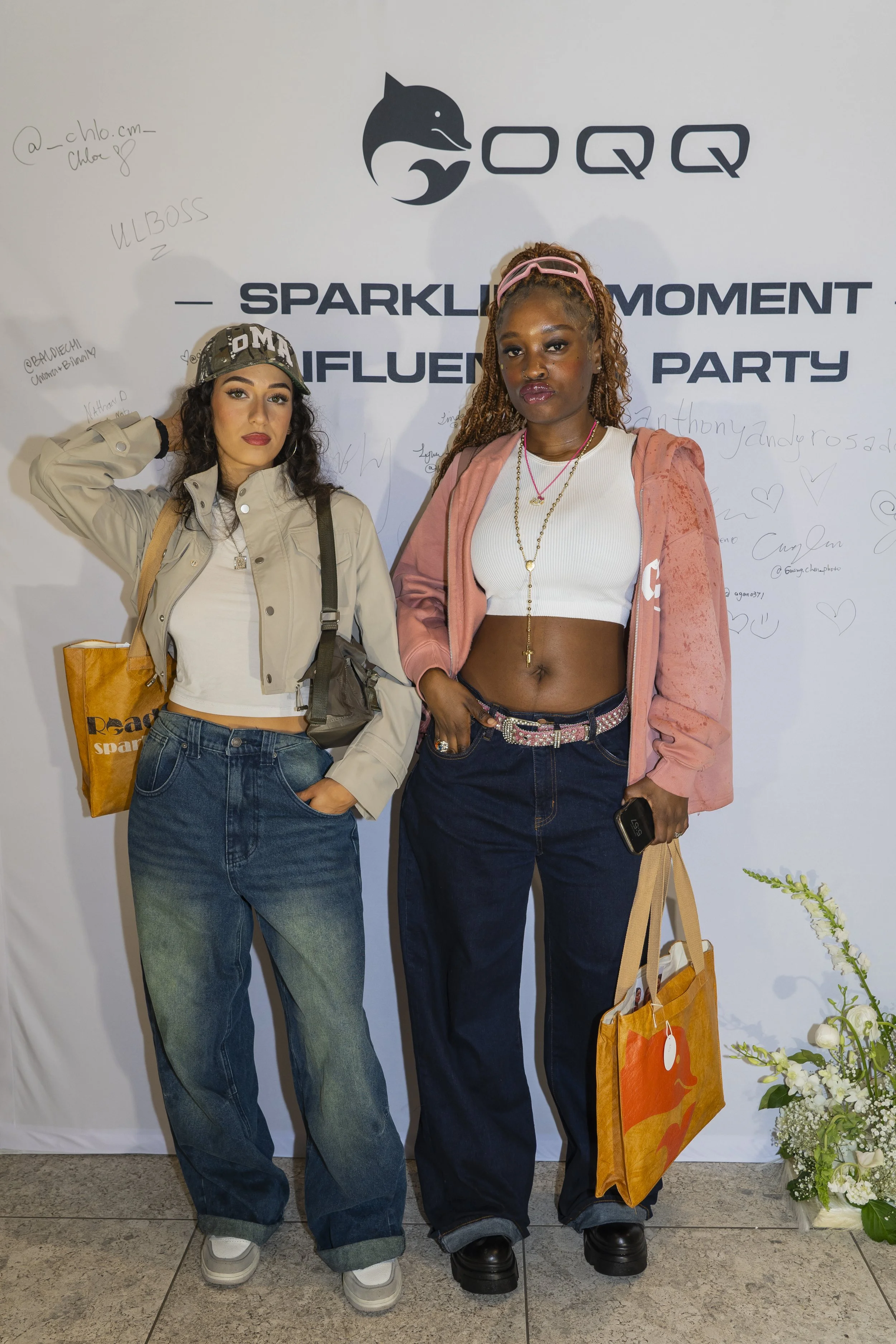 Two fashion influencers captured at the photocall during womenswear brand OQQ's press conference in New York.
