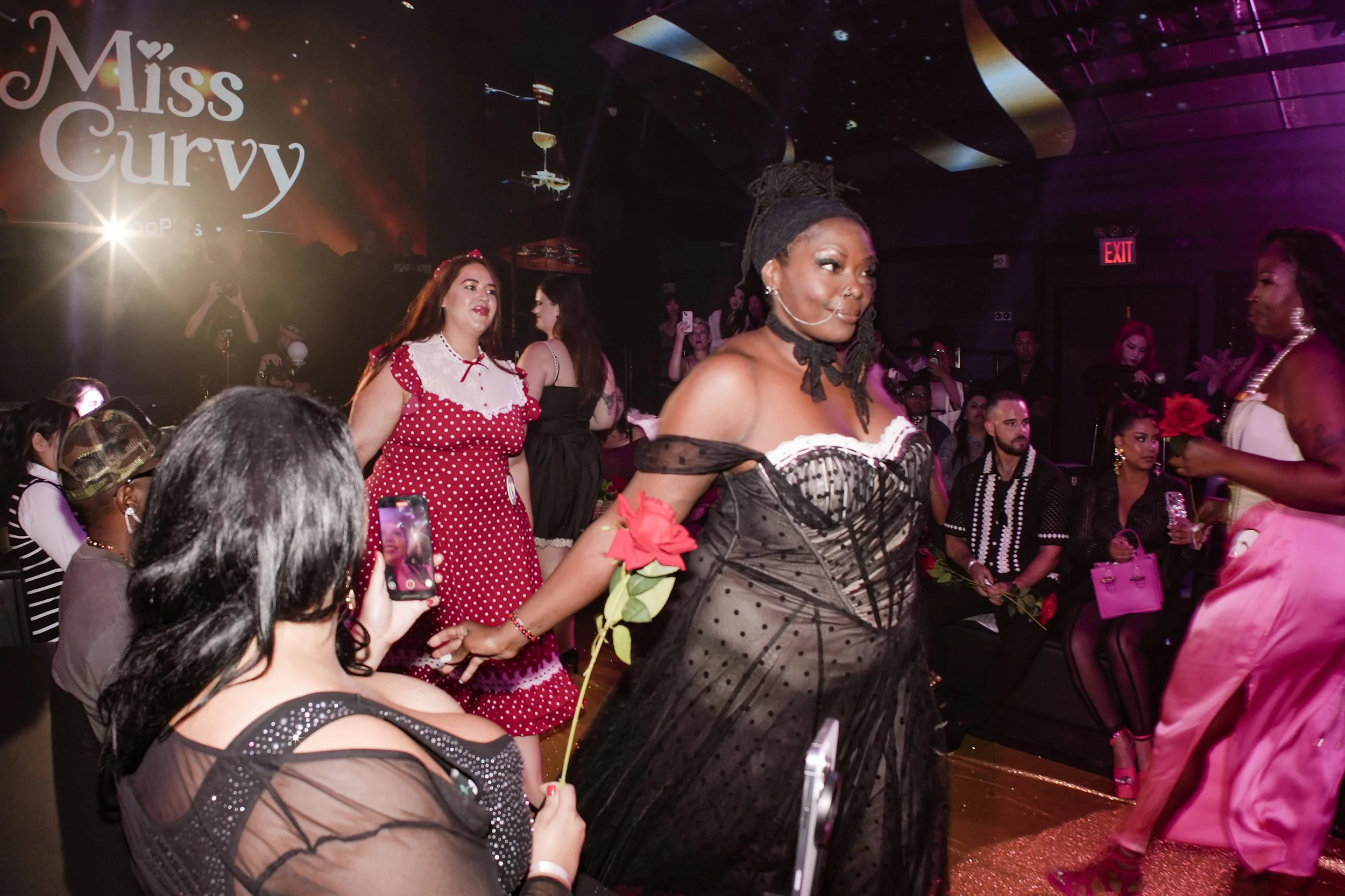 Pageant contestants walking on stage in dresses from womenswear brand Lacemade at the NYFW Miss Curvy Pageant of WooPlus by experiential production agency ANG Concept.