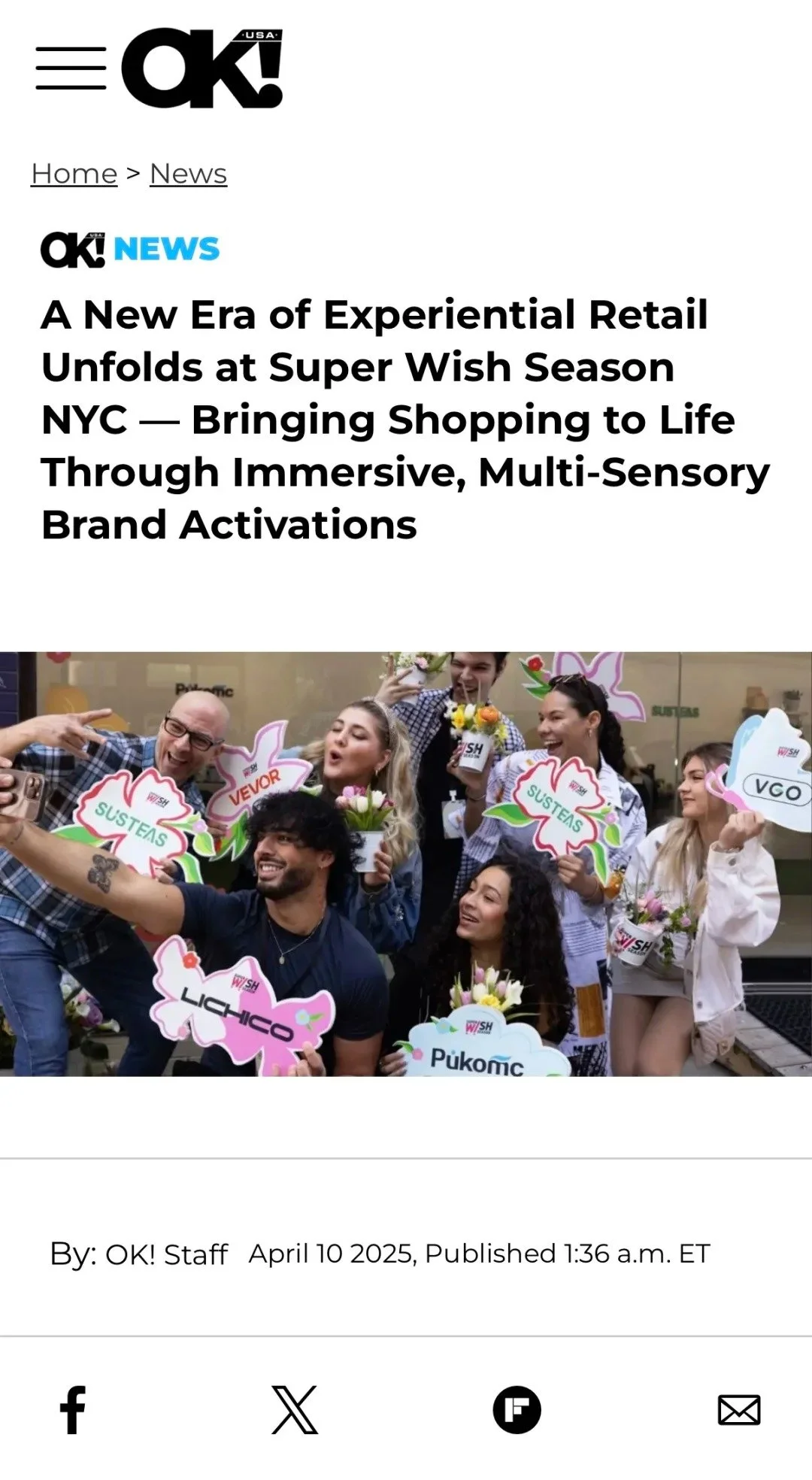 A group of people celebrating with colorful signs and flowers, smiling and taking pictures.