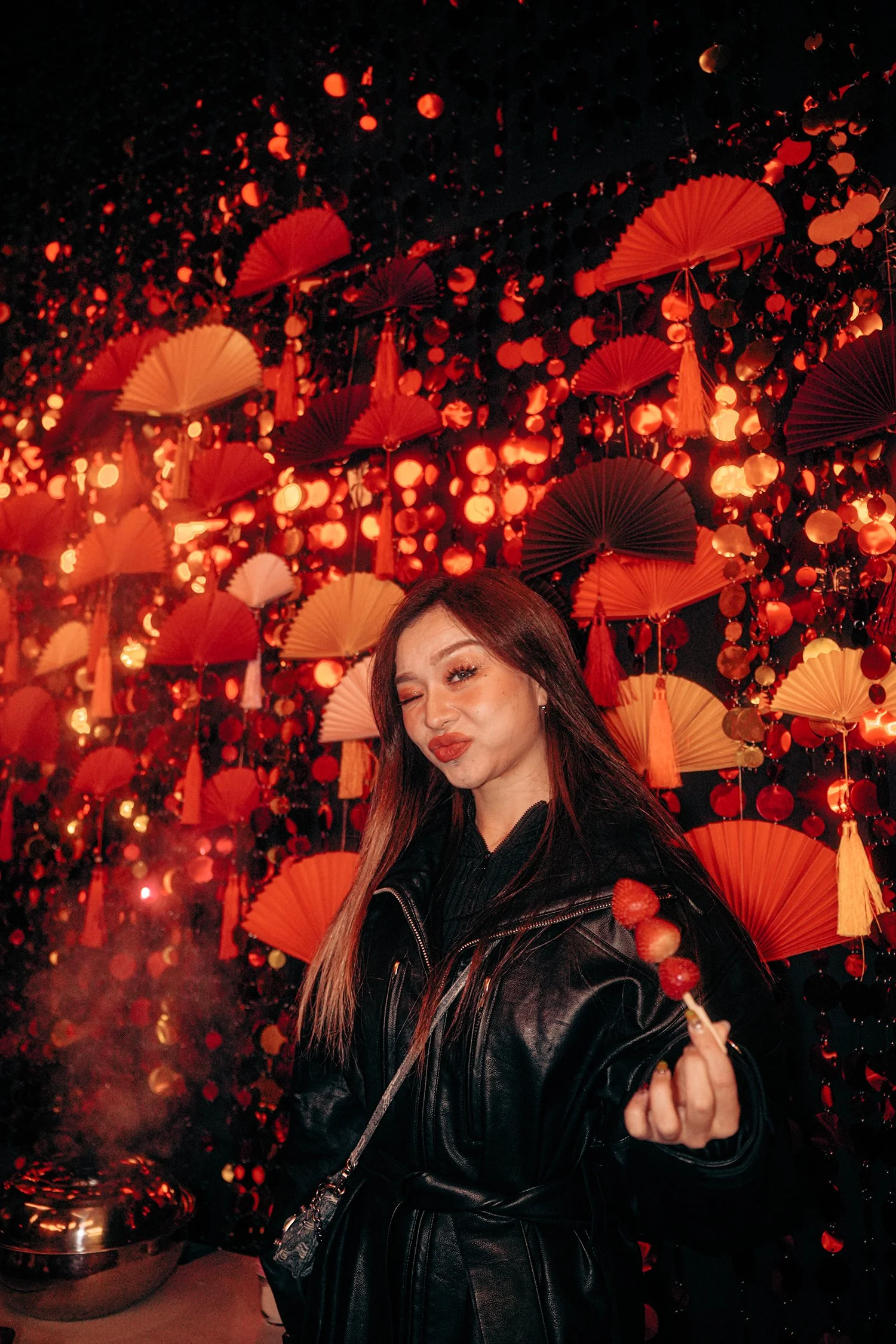 Our party's DJ RoRoll holding the Chinese candied fruit at experiential production agency ANG Concept's Lunar New Year Party.