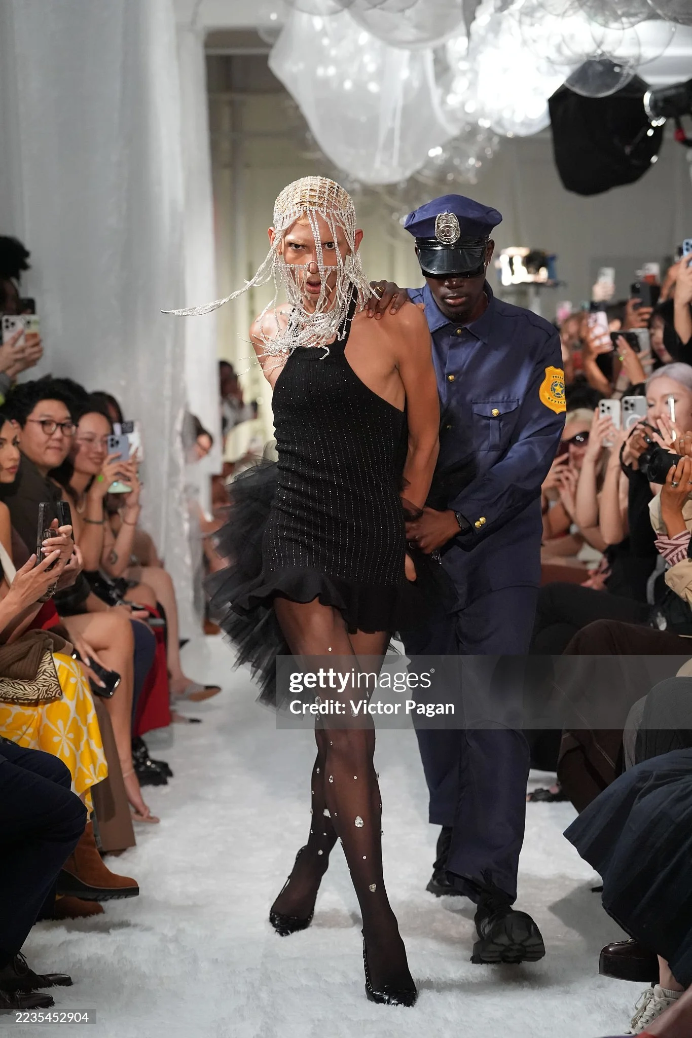 Model in a rebellious act walking down the runway from the theatrical fashion show NYFW SS26 EASTEAM "Rebel Heiress" by experiential production agency ANG Concept. 