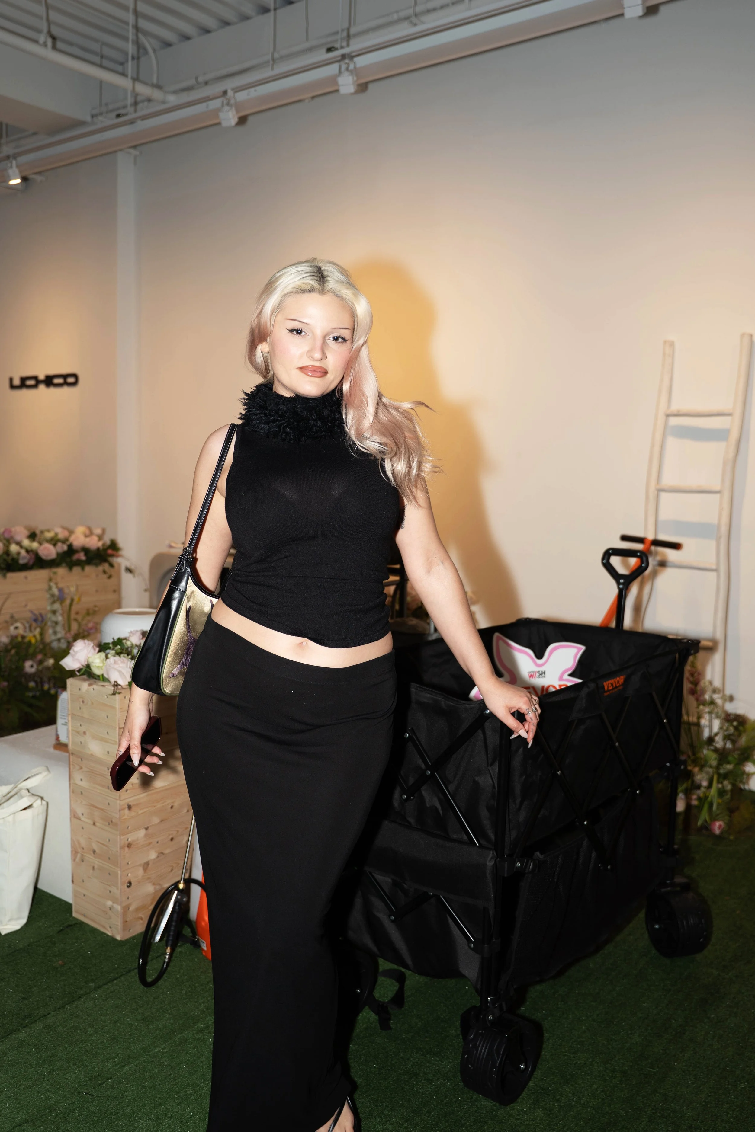 A KOL guest posing with Vevor's wagon product at the TikTok Super Wish Season pop-up activation by experiential production agency ANG Concept.