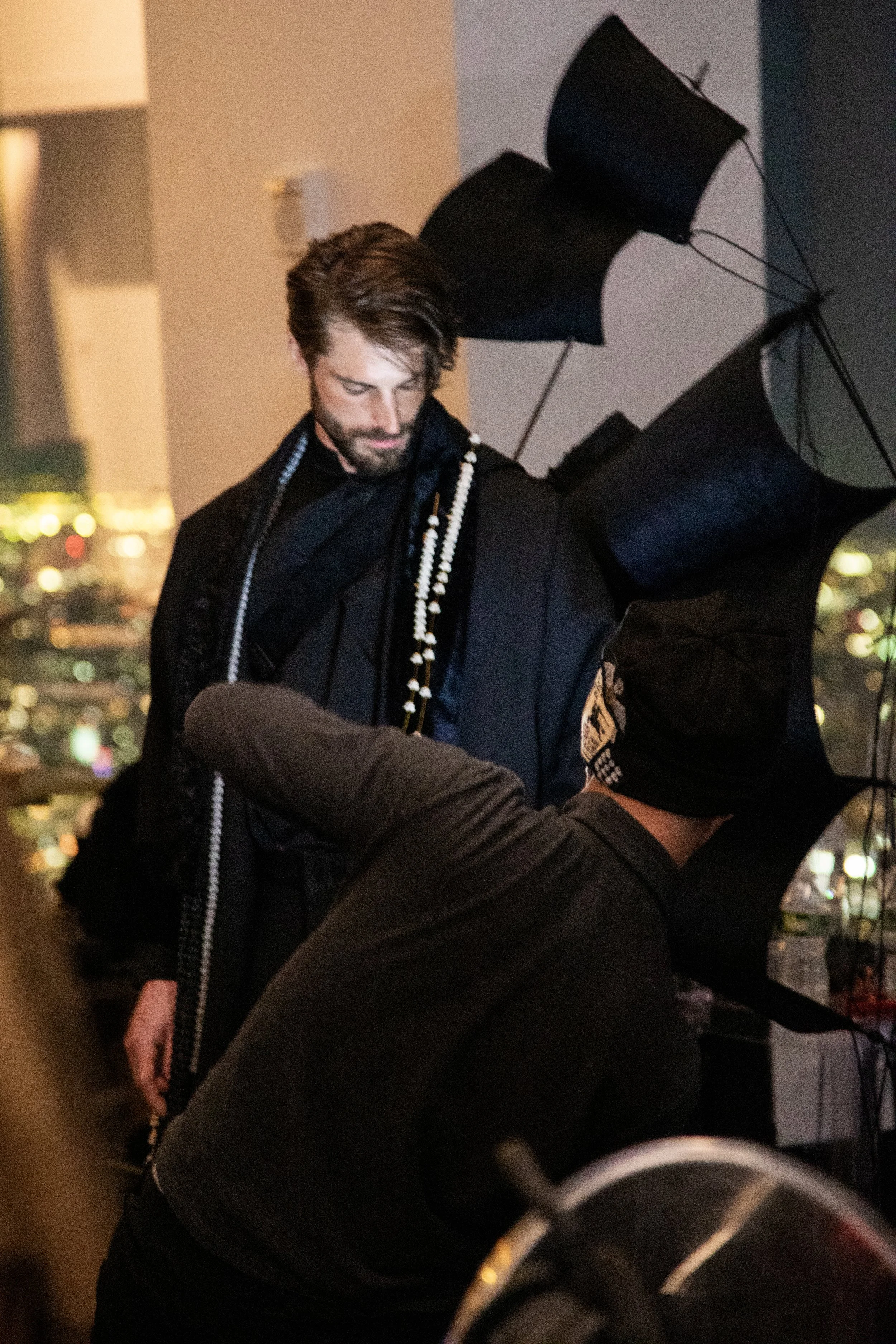 A SARRAN model getting dressed at "Up to the Sky" Bangkok designer fashion show by event production agency ANG Concept during NYFW at One World Observatory.