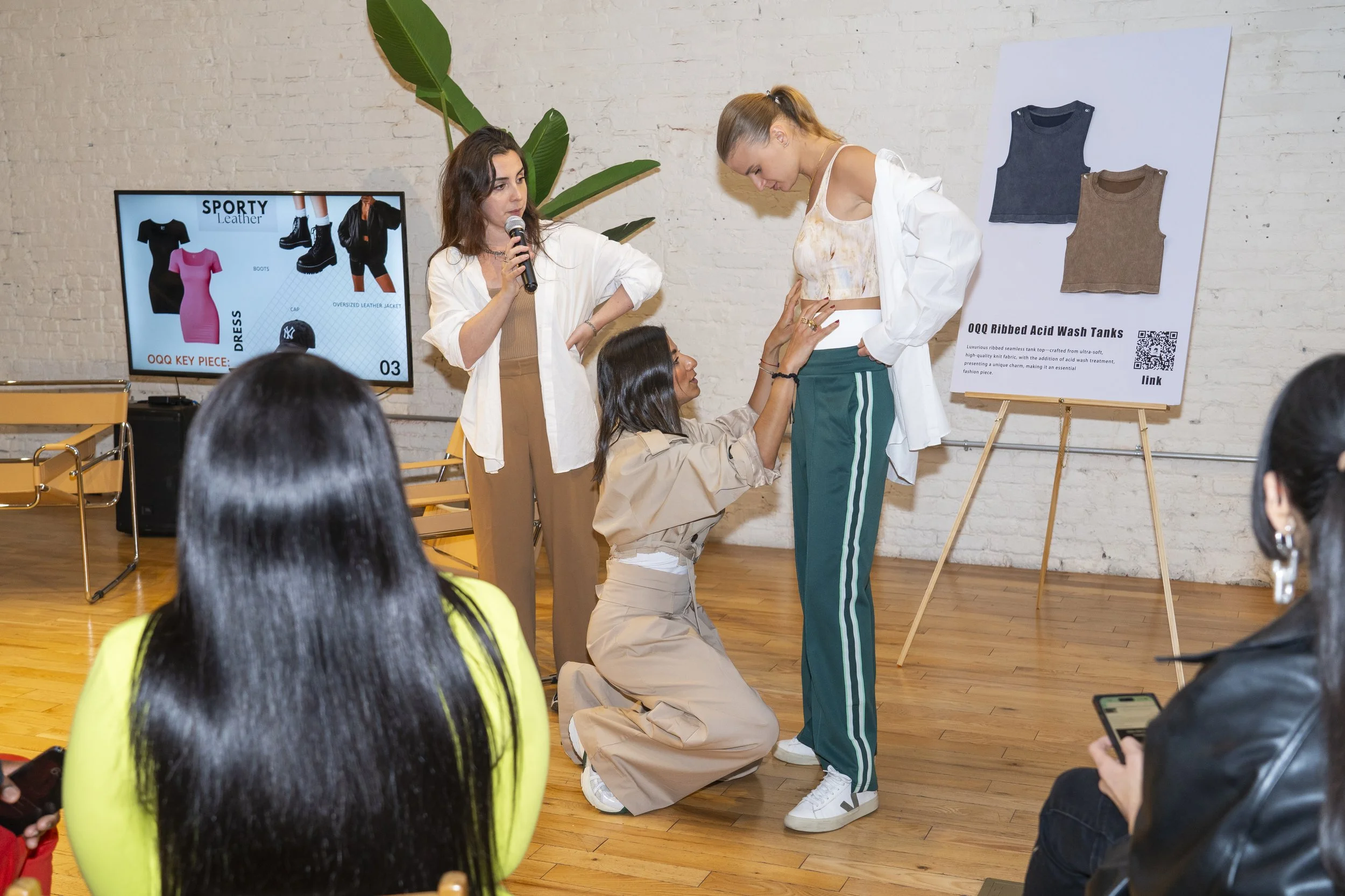 The stylist dressing the model in the fashion presentation of Women's Activewear, Gymwear, and Athleisure brand OQQ's press conference in Williamsburg.
