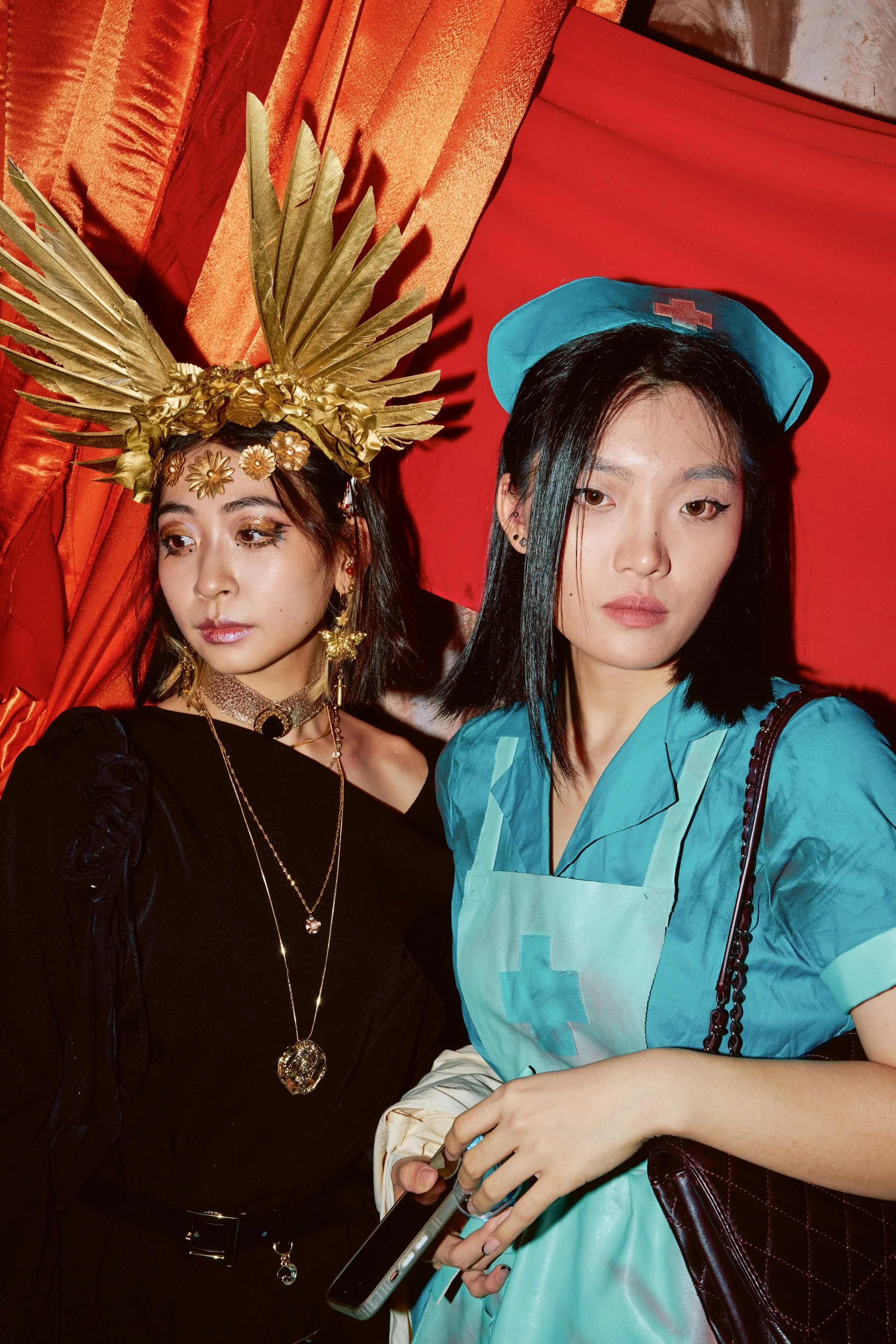 Two guests captured at the photocall for Madame Rouge event in SoHo, a Halloween party by creative production agency ANG Concept.