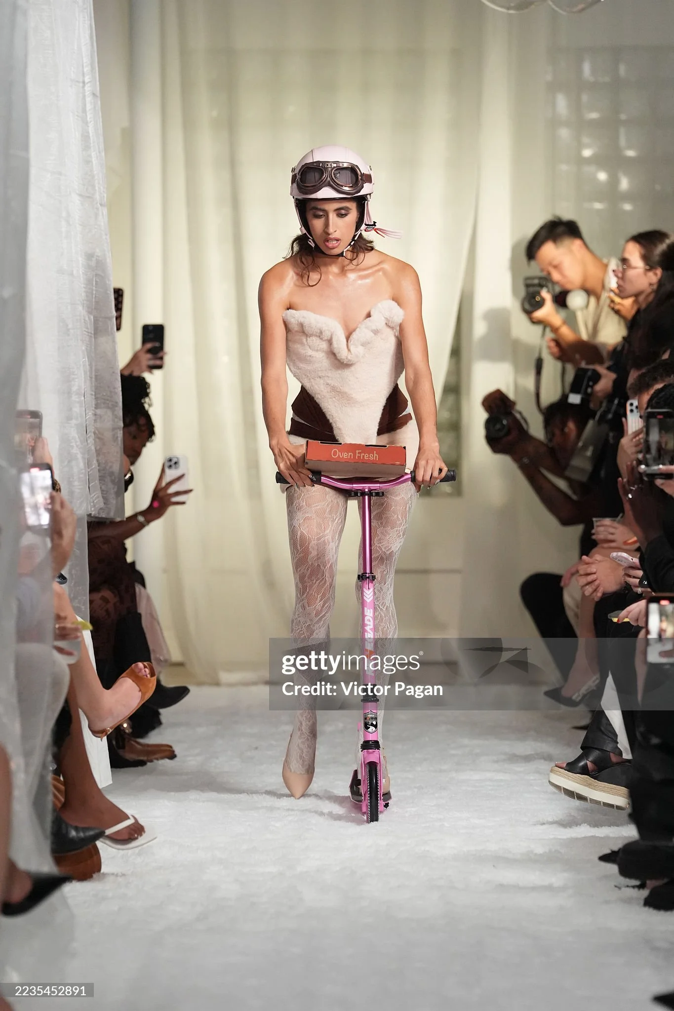 A model scootering down the runway of the theatrical NYFW SS26 EASTEAM "Rebel Heiress" by experiential production agency ANG Concept.