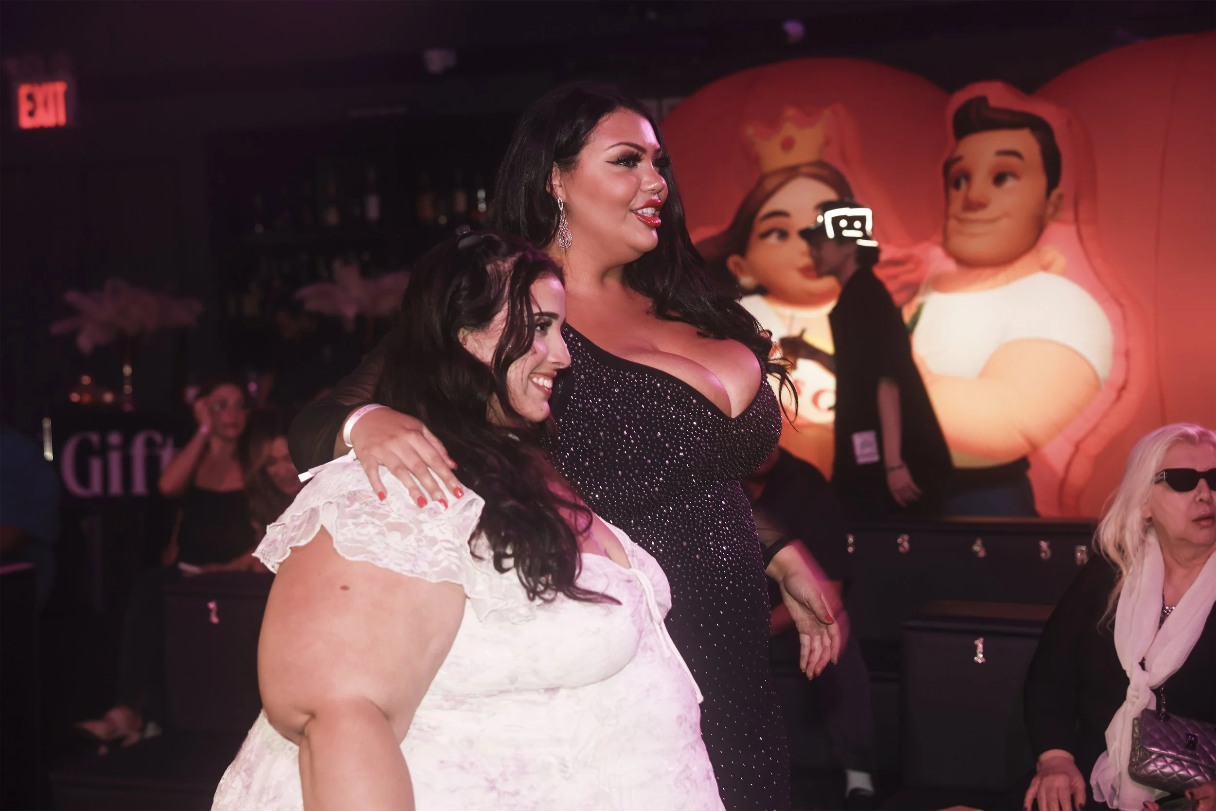 KOL and the host posting in front of the branded inflatable for Miss Curvy Pageant, a NYFW runway show of dating app WooPlus by event production agency ANG Concept.