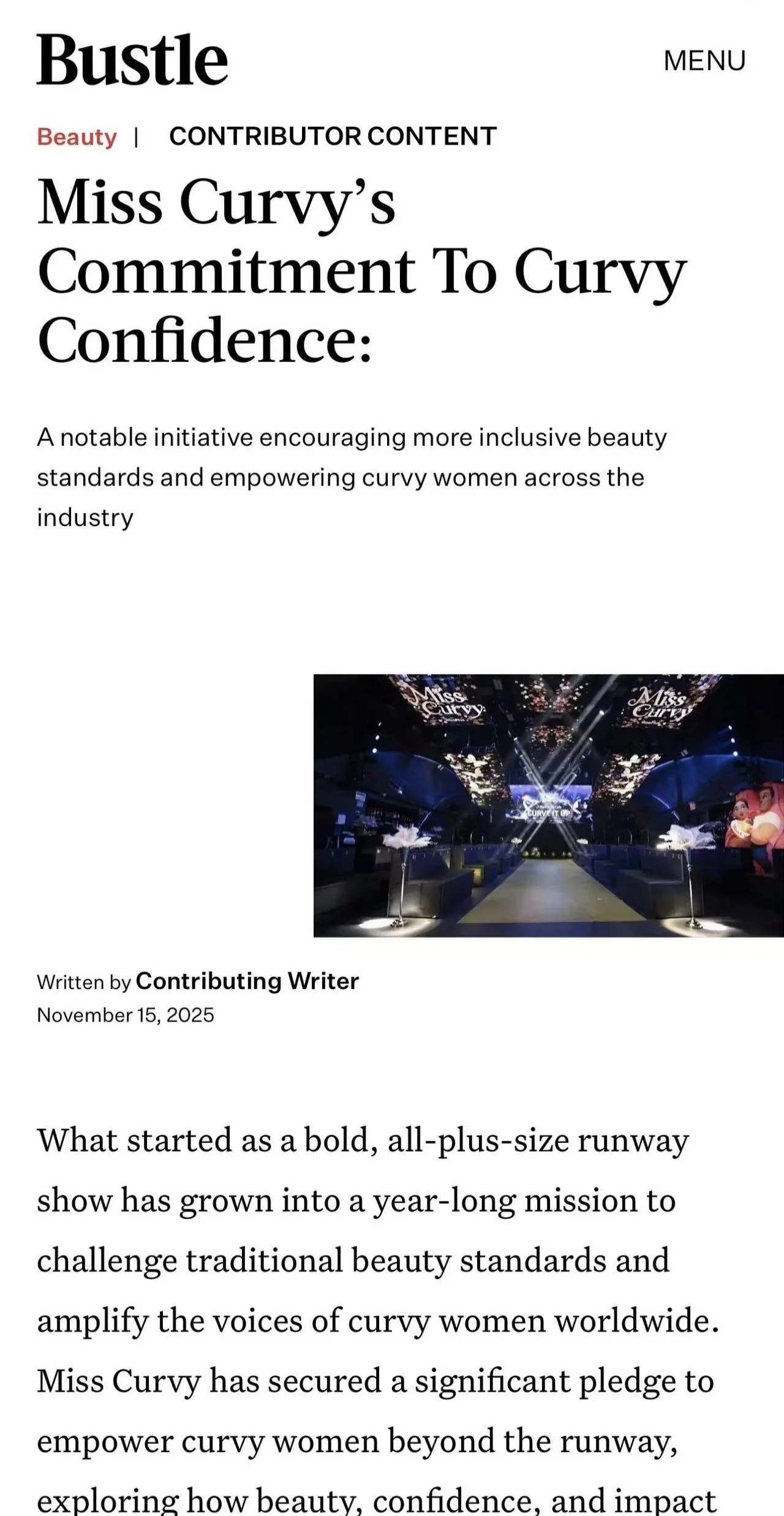 A dimly lit runway with Miss Curvy signage projected on screens overhead, flanked by seating areas and decorative feather arrangements.