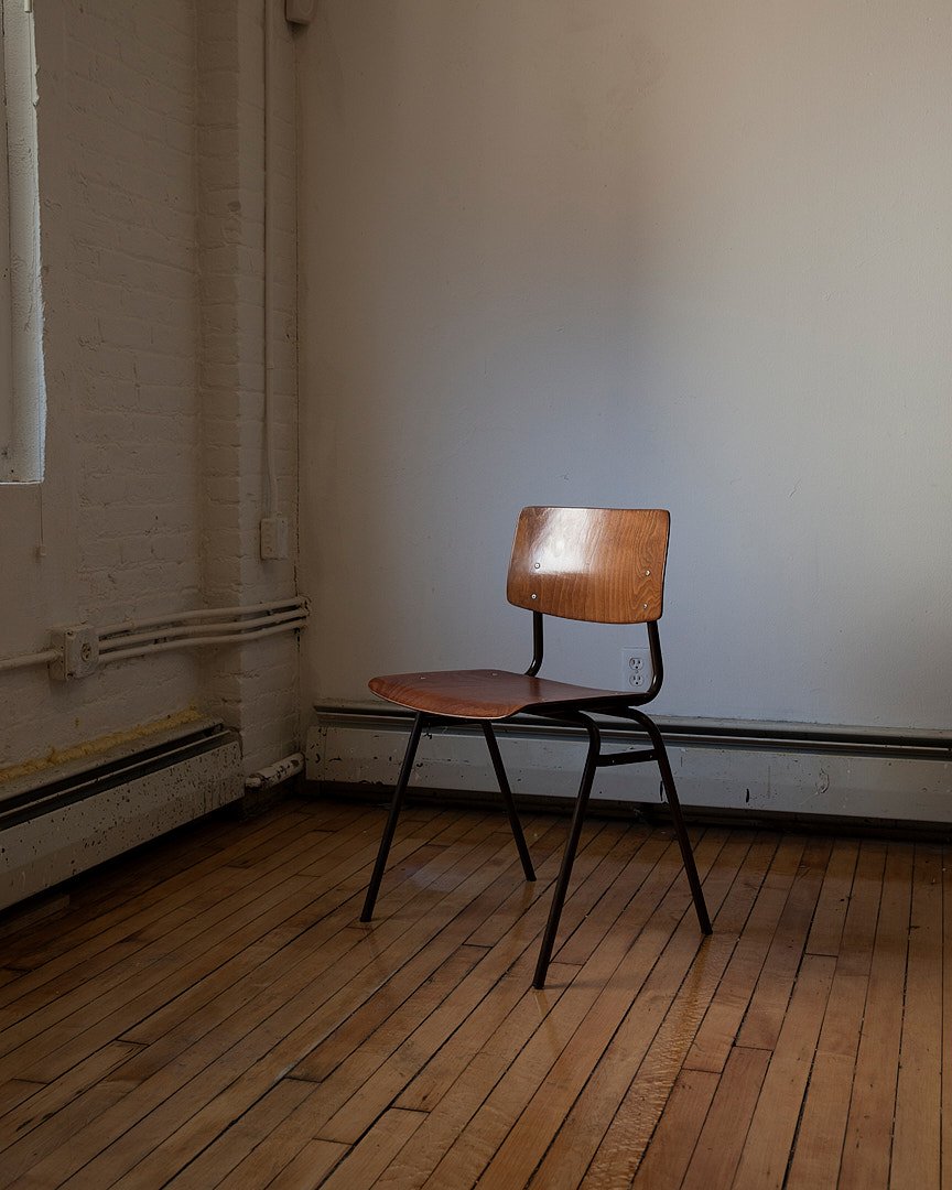 Colour photograph of a chair in a portrait studio