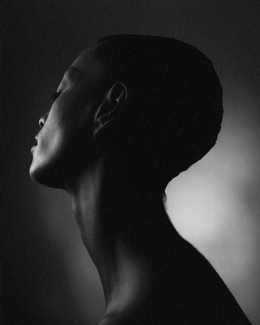 Black and white profile portrait of beautiful woman with long neck
