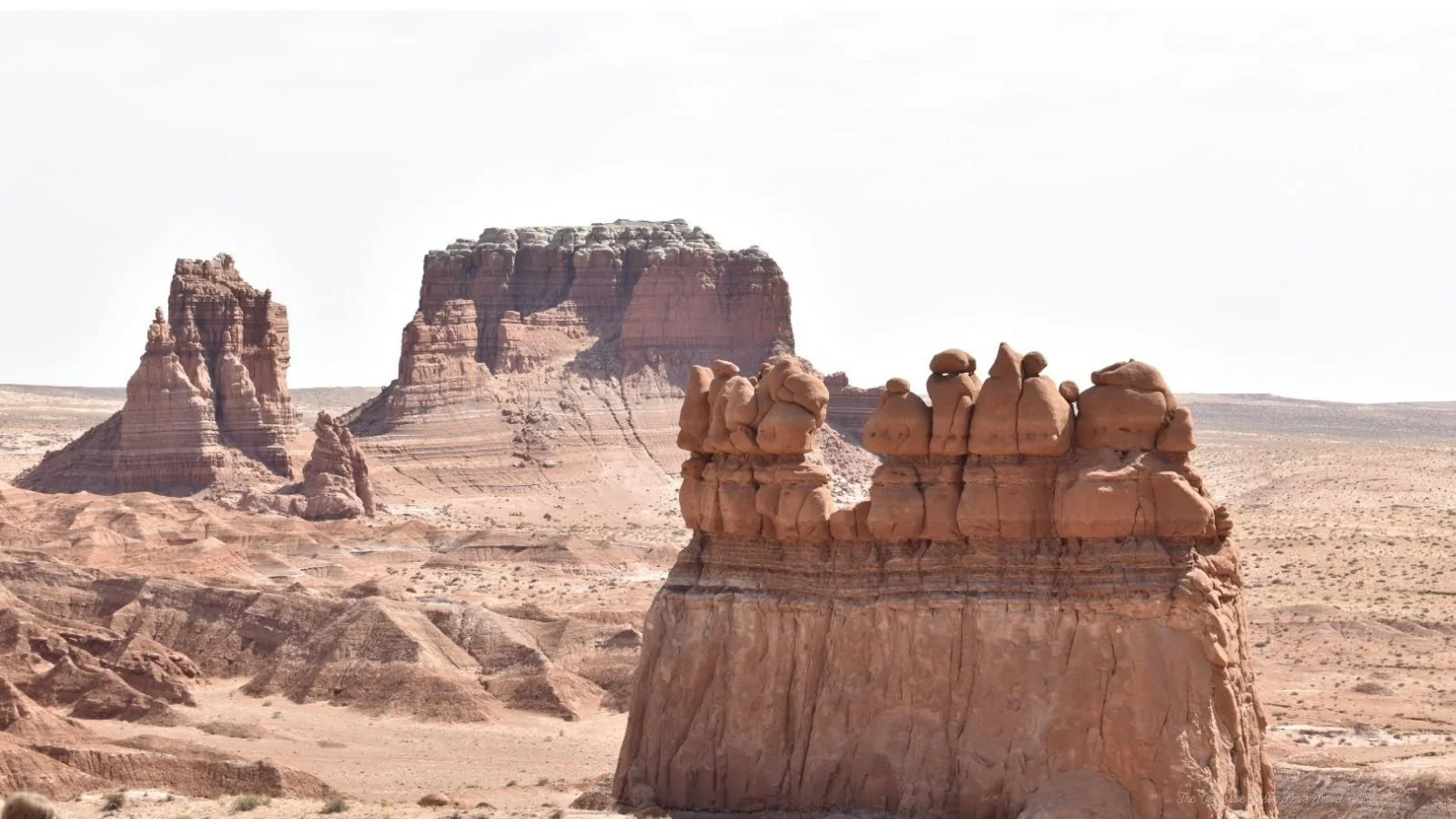 Desert landscape with large rock formations under a clear sky