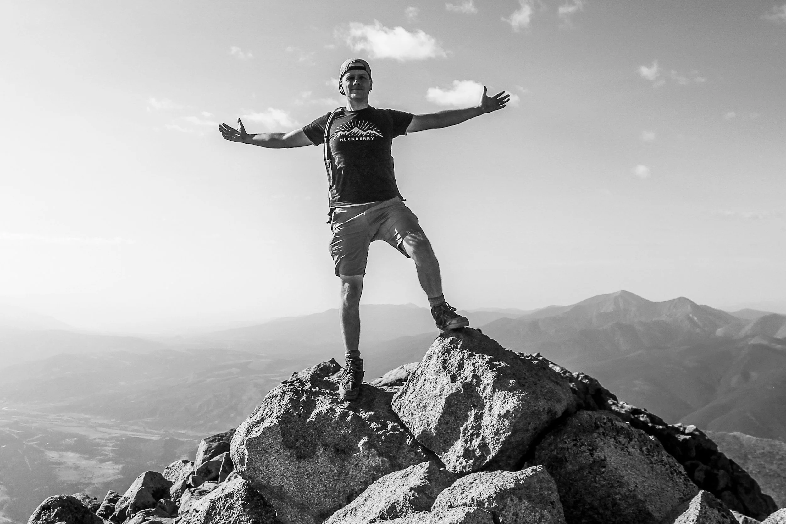 A person standing on a mountain summit, representing freedom from subconscious limitations at Timpanogos Hypnotherapy in Provo Utah.
