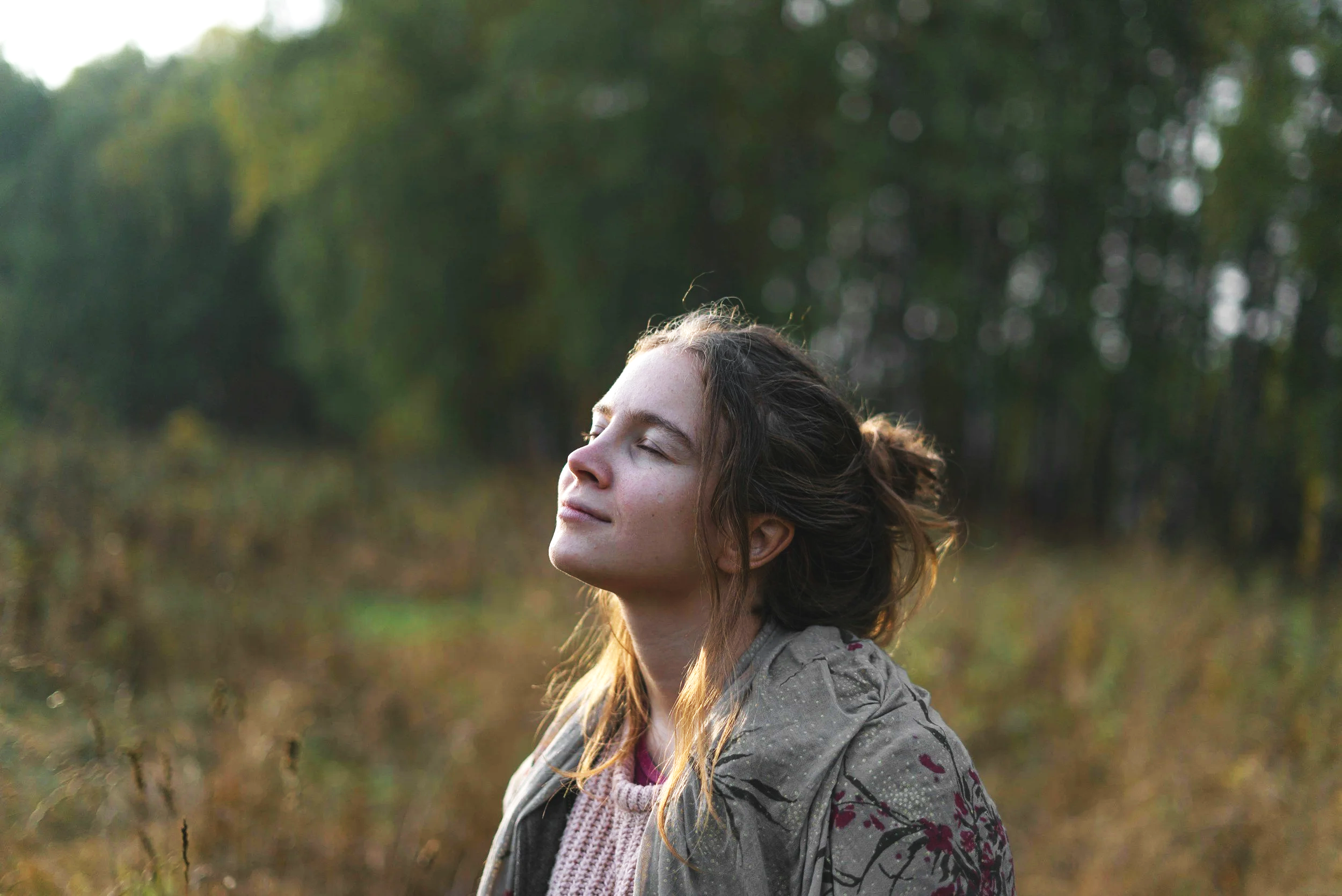 Young woman taking a deep calm breath outdoors representing in-person and online anxiety hypnotherapy at Timpanogos Hypnotherapy in Provo Utah and nationwide