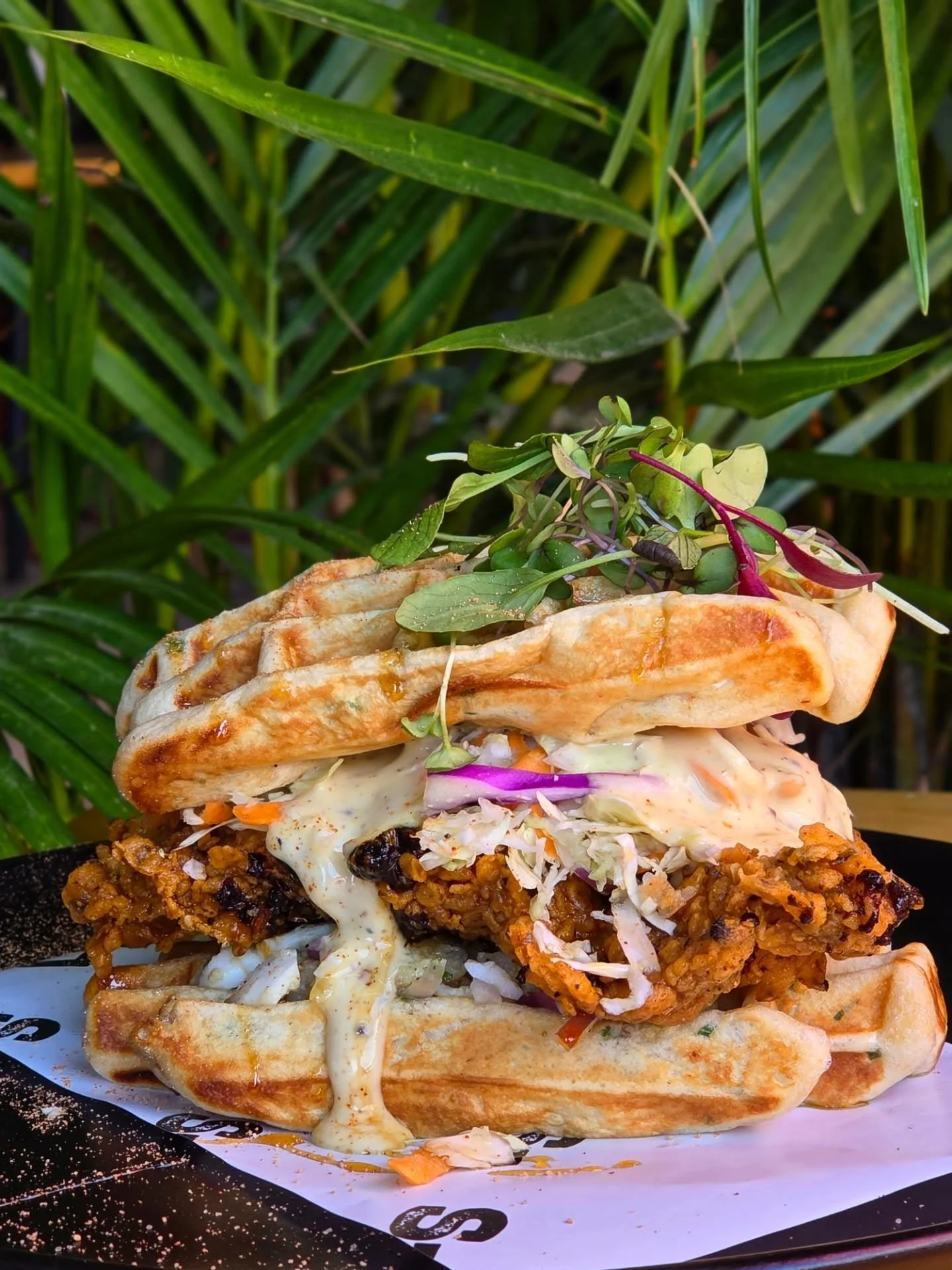 𝐖𝐚𝐟𝐟𝐥𝐞 𝐌𝐲 𝐂𝐡𝐢𝐜𝐤𝐞𝐧 🧇 🐔 🔥 
Yeah... we did that.
Crispy Nashville chicken stacked between buttery garlic waffles with crunchy slaw, creamy potato salad &amp; maple syrup dripping all over. 

Sweet.Spicy.Crispy 
A whole new level of mes