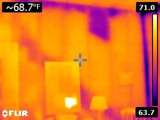 Thermal image of an interior room showing temperature patterns on the walls during a home inspection to check for hidden moisture and insulation issues.