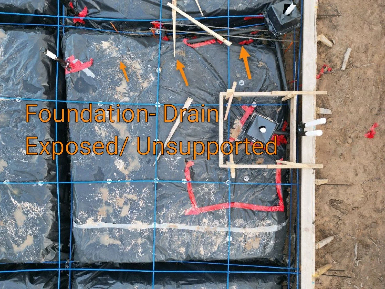 Drone image of a Phase 1 pre-pour foundation inspection focused on the bathroom area, showing under-slab drain and vent plumbing layout inside the slab footprint before concrete is placed.