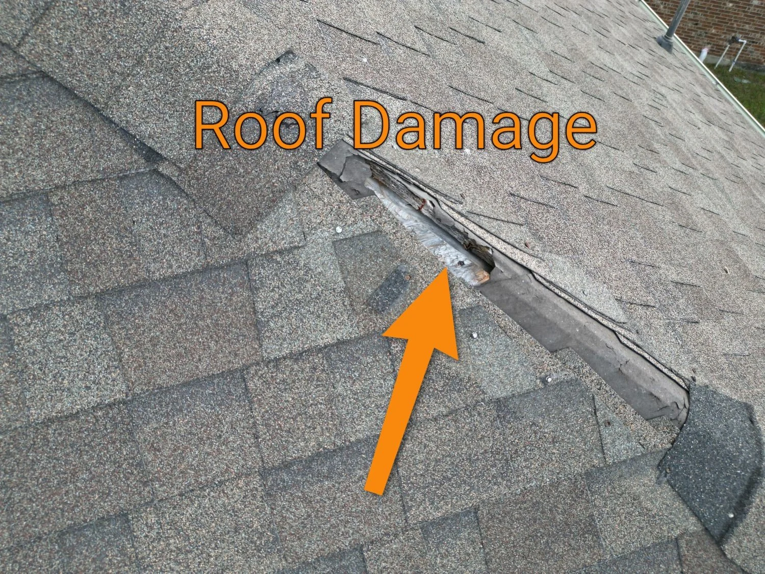 Drone photo of a residential roof in Spring, Texas with severe damage, including missing shingles and exposed underlayment.