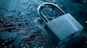 Close-up of a silver padlock on a dark electronic circuit board.