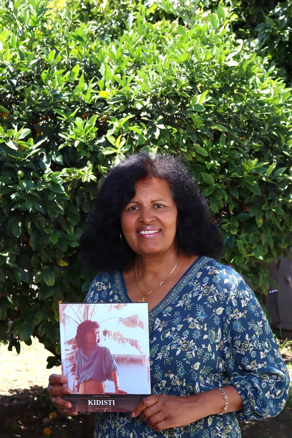 Kidisti holding her Legacy Storybook memoir — life story book service Los Angeles
