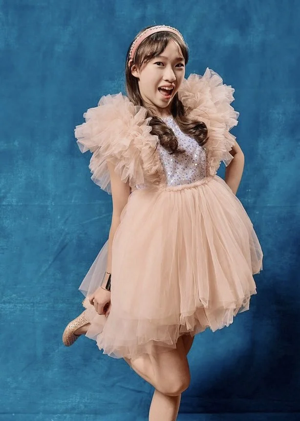 Reagan is wearing Merida Sequin Tutu in Peach