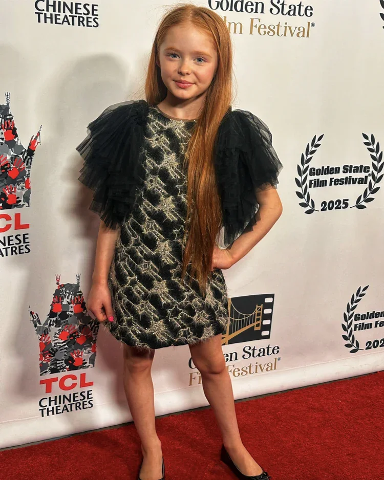 Kynlee is wearing Sonata Tulle Sleeve Tweed Mini Black Dress