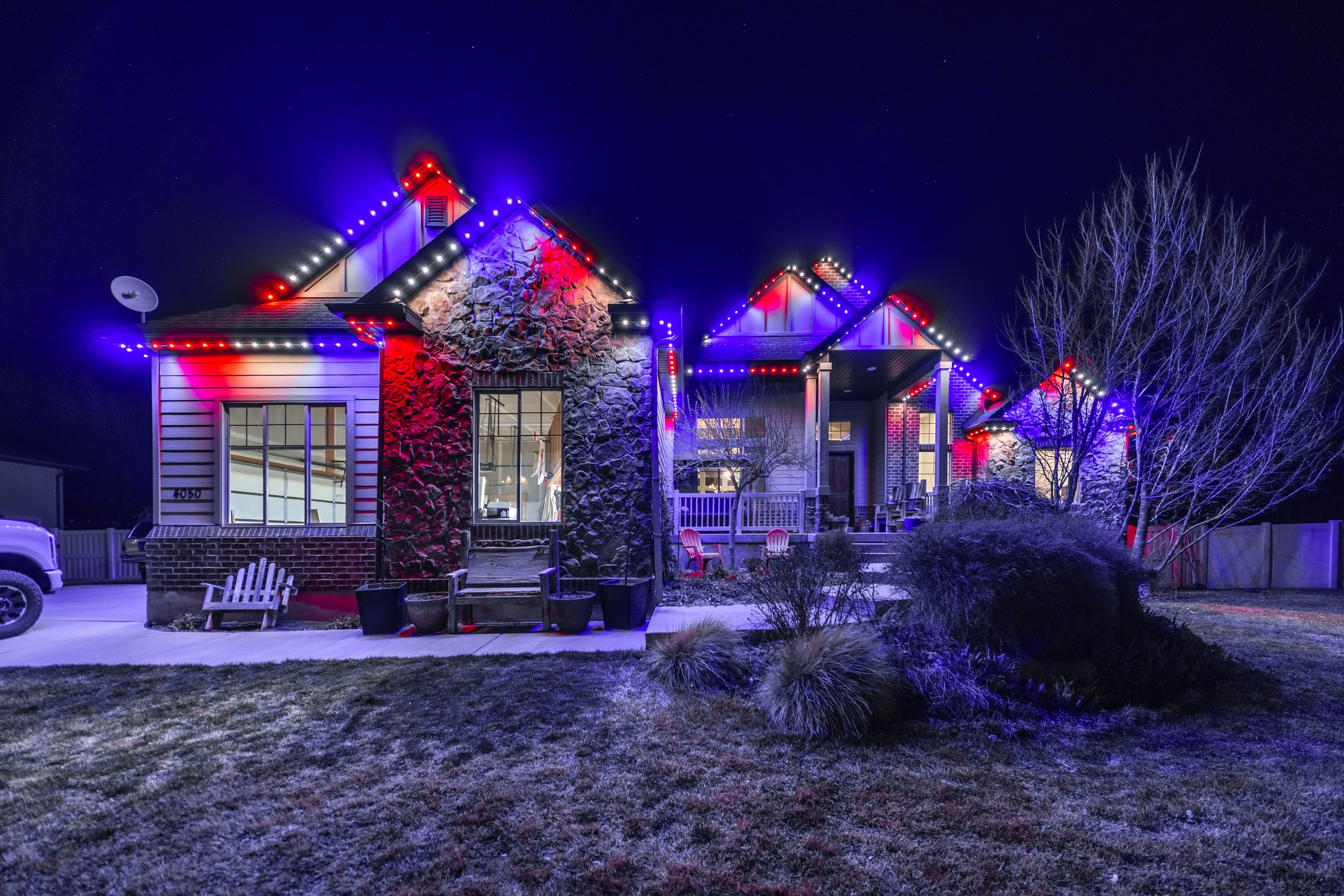 Utah home decorated with red, white, and blue permanent outdoor lighting for holiday and year-round use.