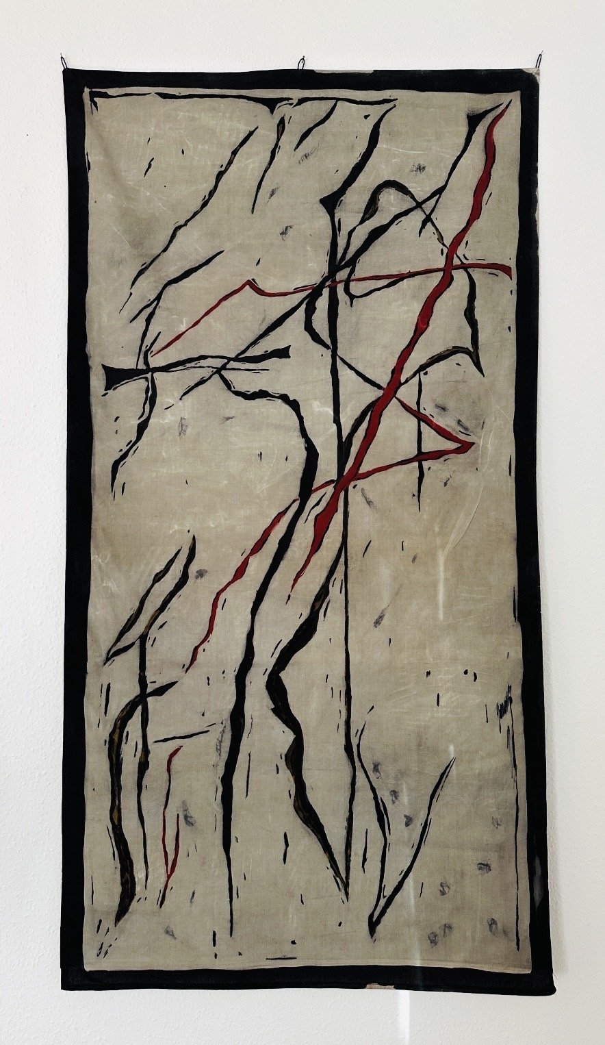 The Curse- Pale batik textile artwork with red diagonal line by Viktoria Vigh