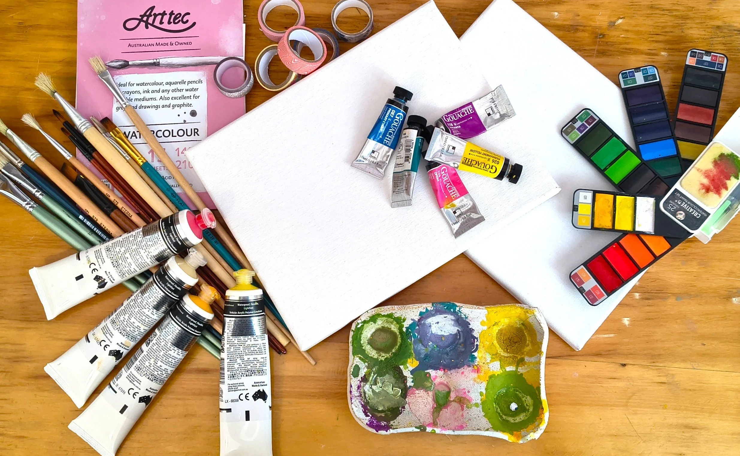 Art supplies spilled over a table