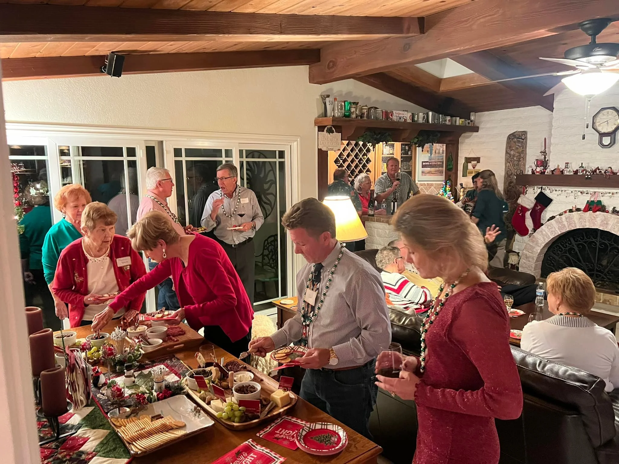 group getting food at Christmas Dinner 2023.jpg