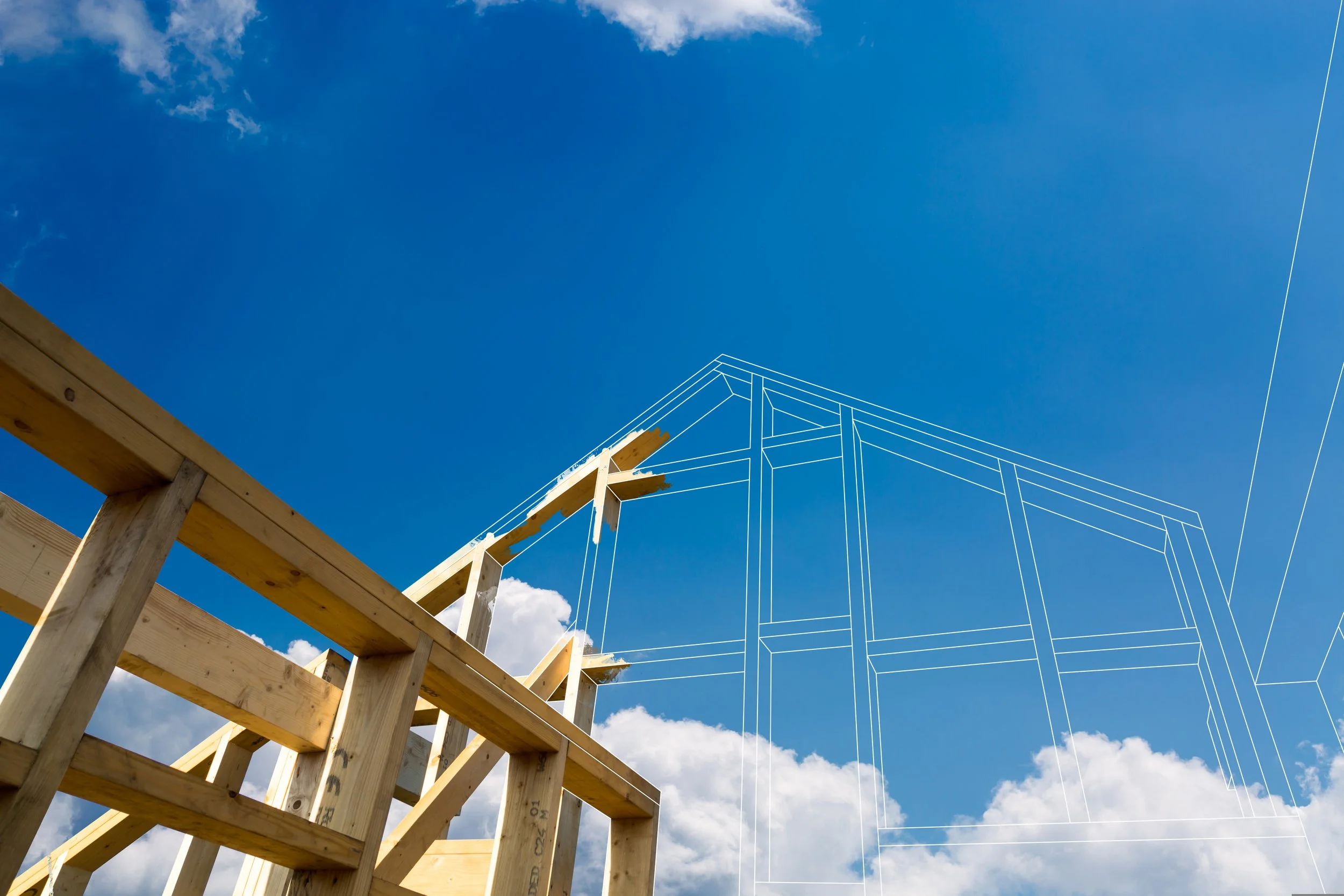 Wooden construction framework with a digital outline overlay of a house against a blue sky with clouds.