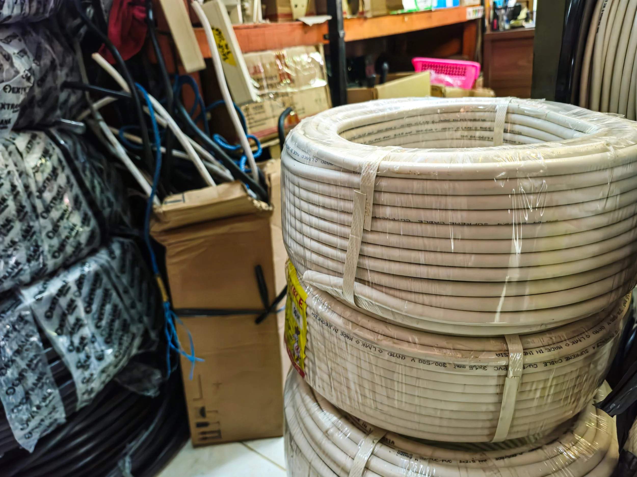 Coiled white plastic tubing stacked in bulk.