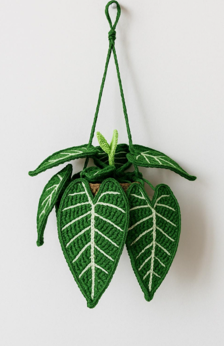 A decorative hanging plant made of felt leaves with a pot at the center, suspended by a green cord.