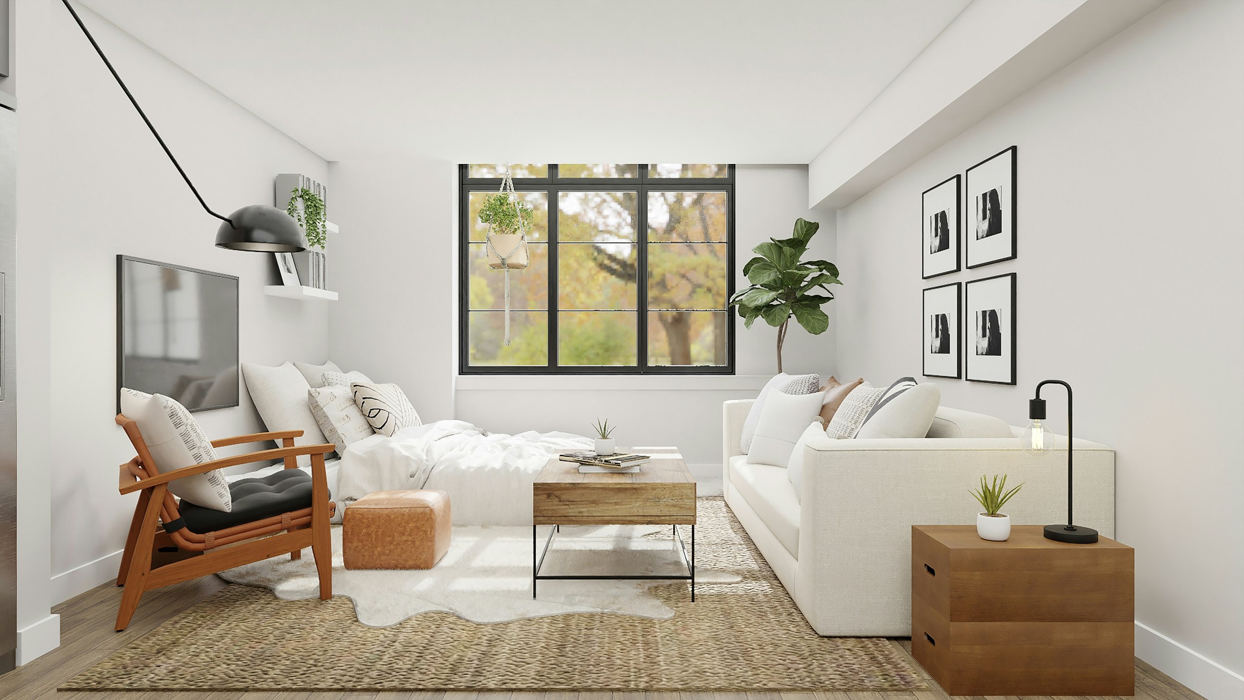 Bright living room with a large window, white walls, a white sofa, a black round table, and wall art in black and white.