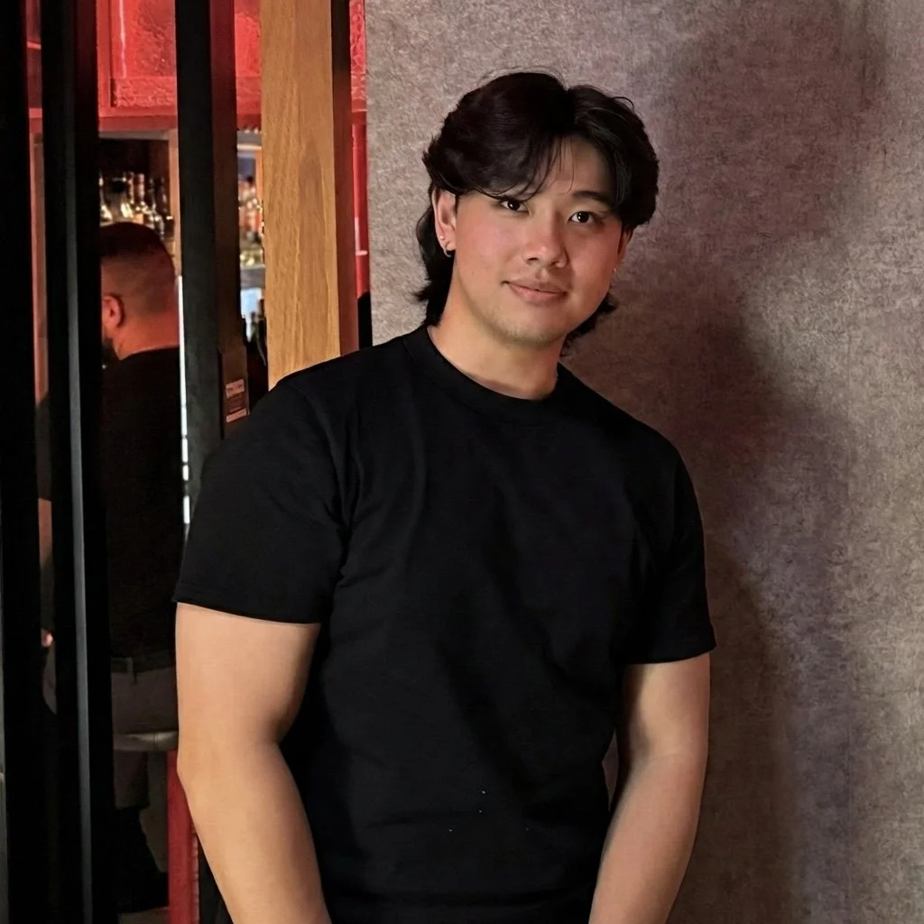 Headshot of smiling male tutor with short locks wearing a lanyard.