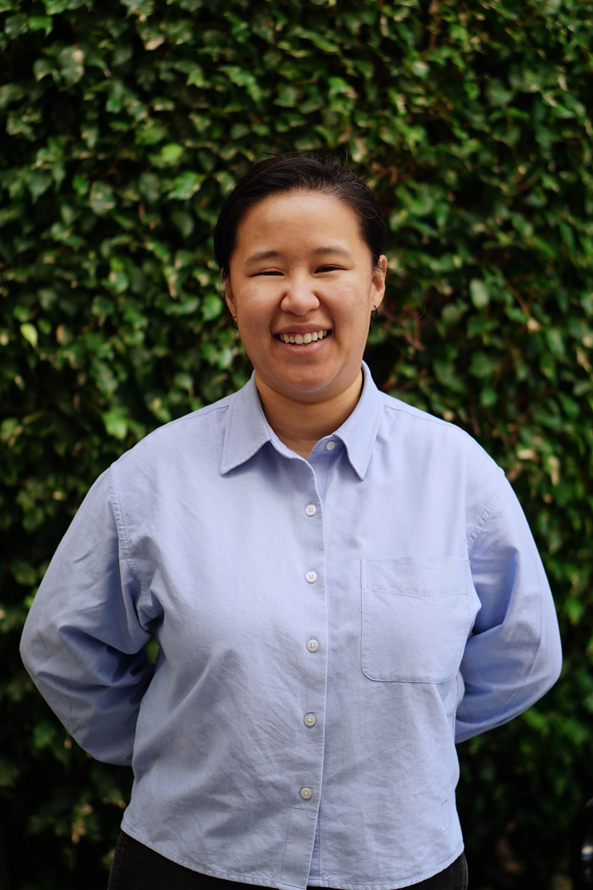 Headshot of smiling female tutor with short blonde hair wearing a lanyard.