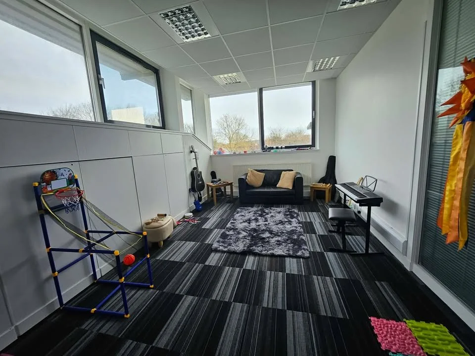 A creative and engaging space where individuals can explore music, express themselves, and build confidence. Equipped with instruments including a keyboard and guitars, as well as a cosy seating area, this room supports both structured sessions and f