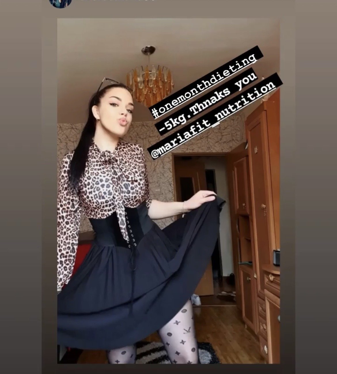 A woman with long dark hair wearing a leopard print blouse, a corset, and patterned tights making a kissing face while holding up her skirt to show her legs. There is text overlay thanking for nutritional support and mentioning a 5kg weight loss. The