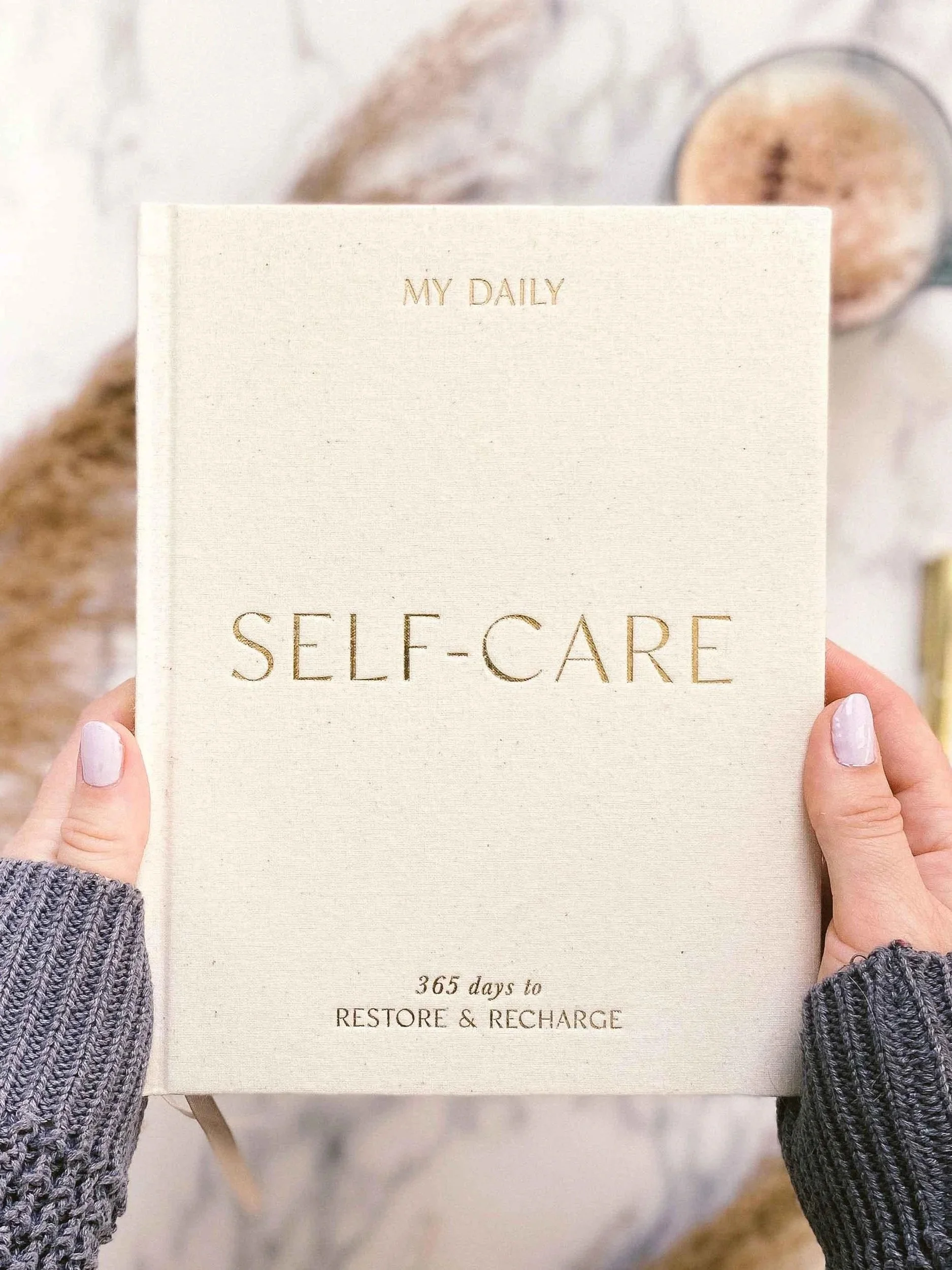 Person holding a self-care book, representing taking a meaningful step toward personal well-being