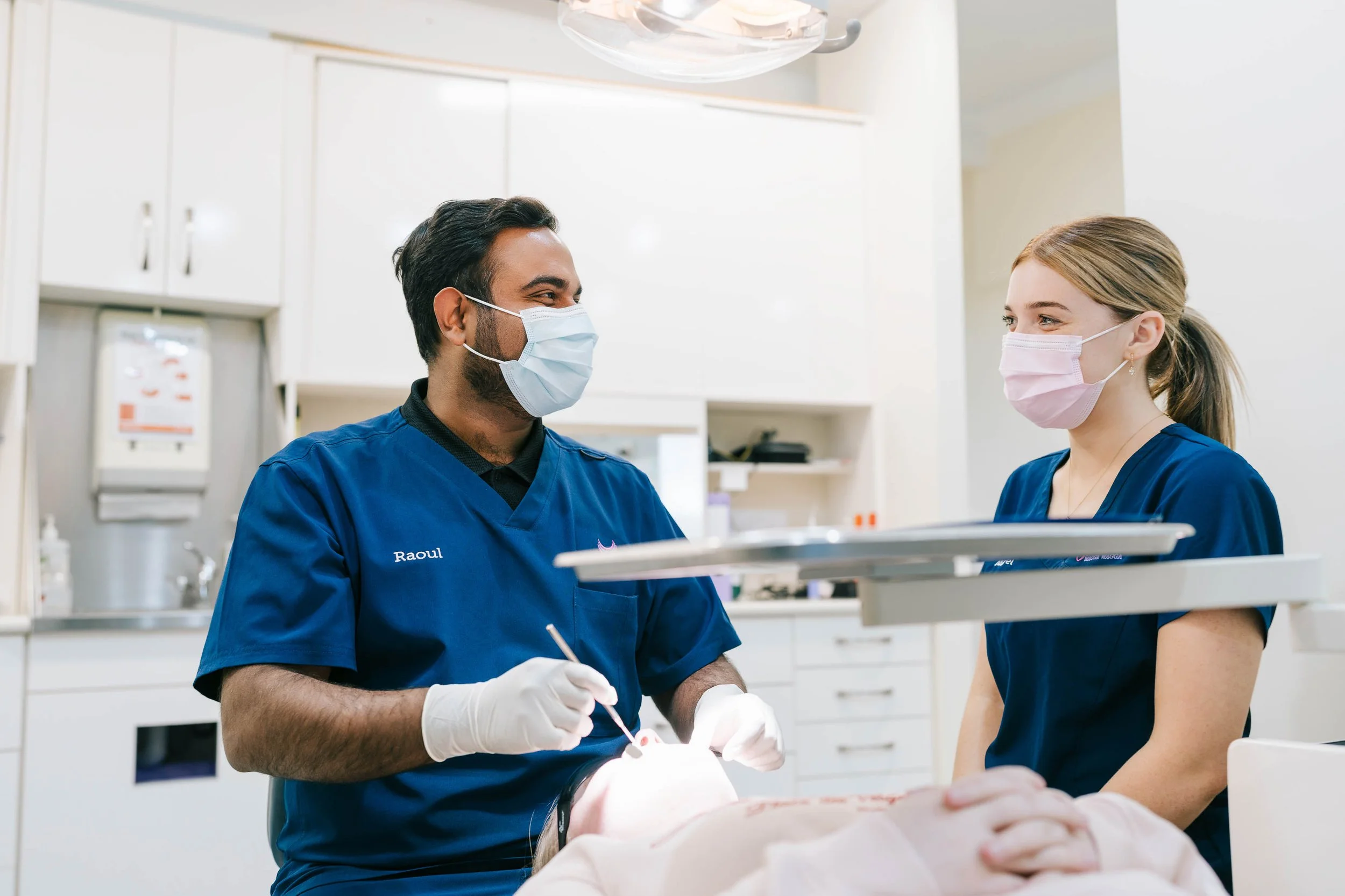 Raoul Mascarenha working with dental assistant in a clinical setting.