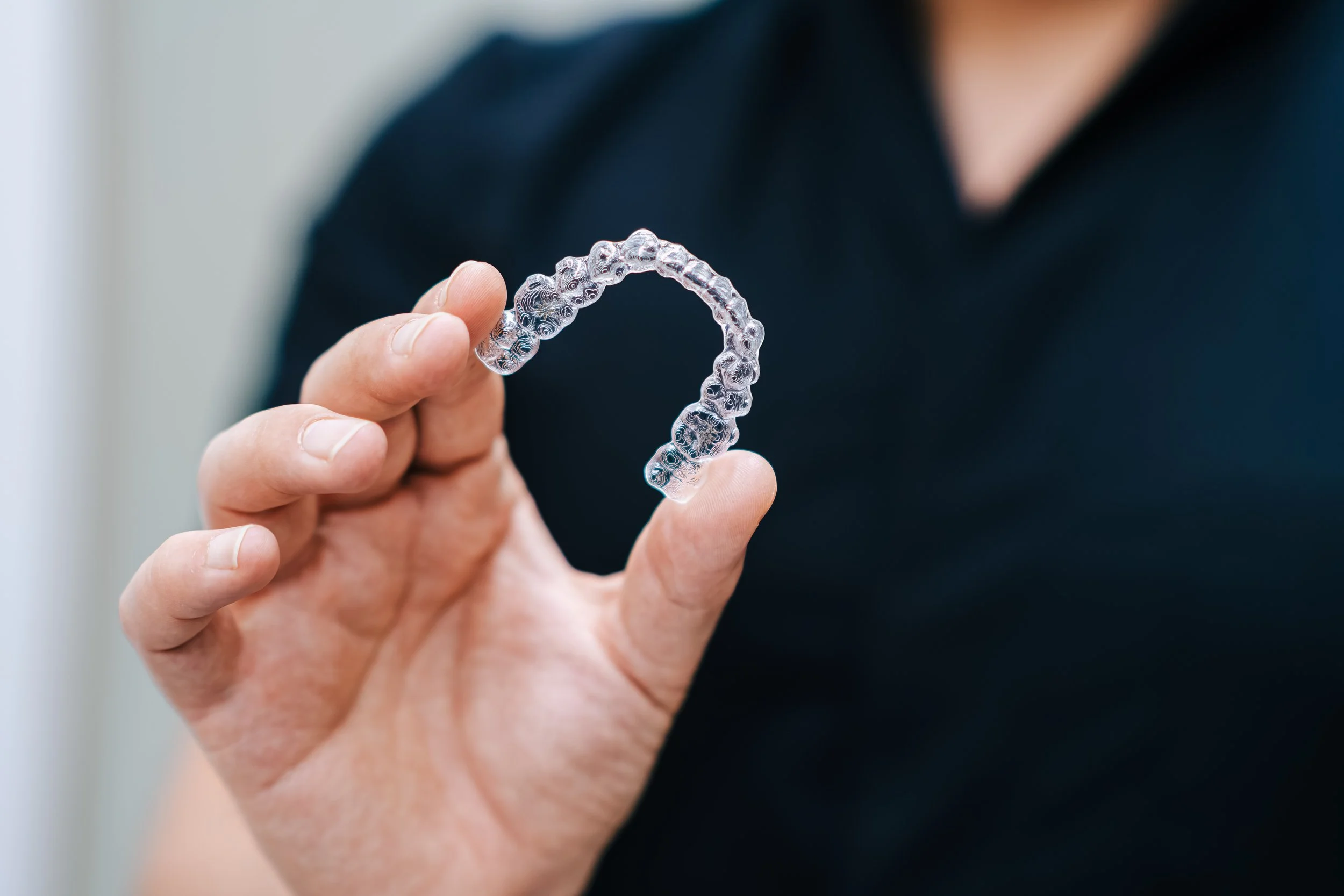 Dental assistant holding a clear Inviligner
