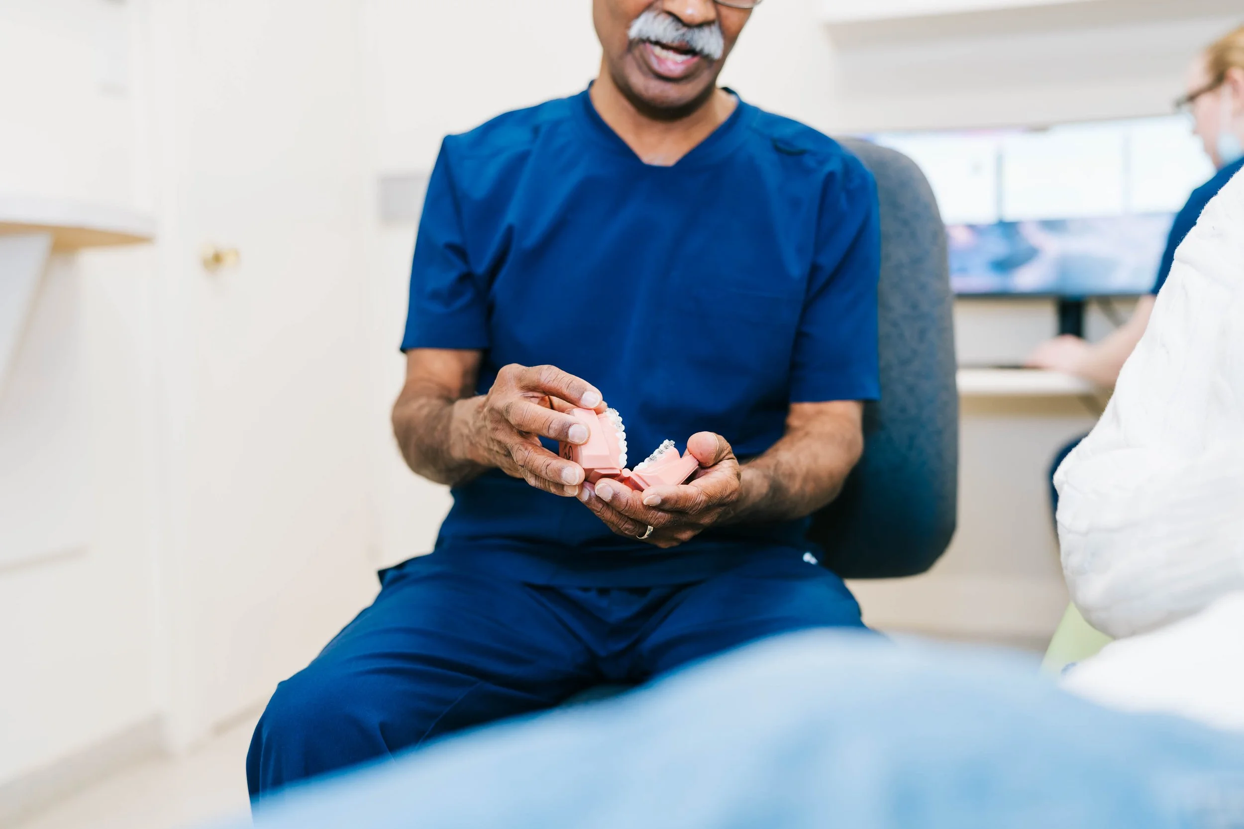 Orthodontist holding a dental model.