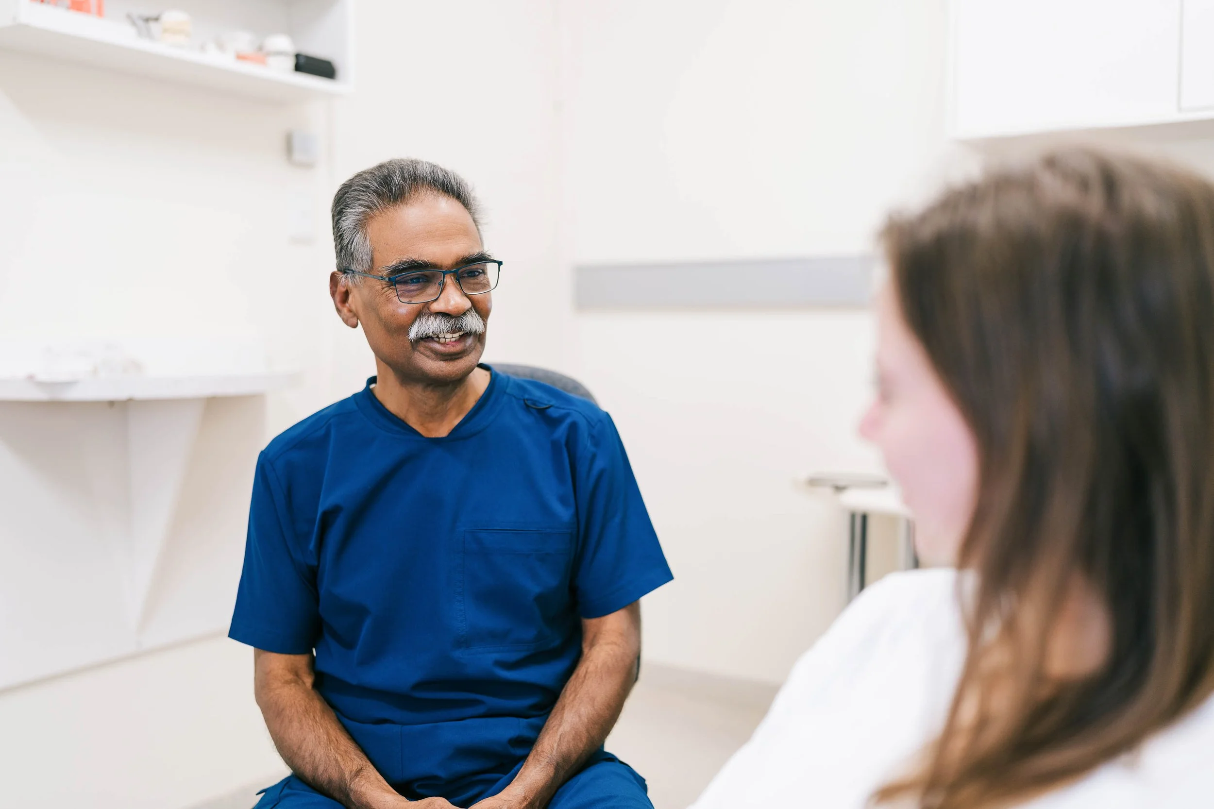 Neil Pinto, Orthodontist, consulting with a patient