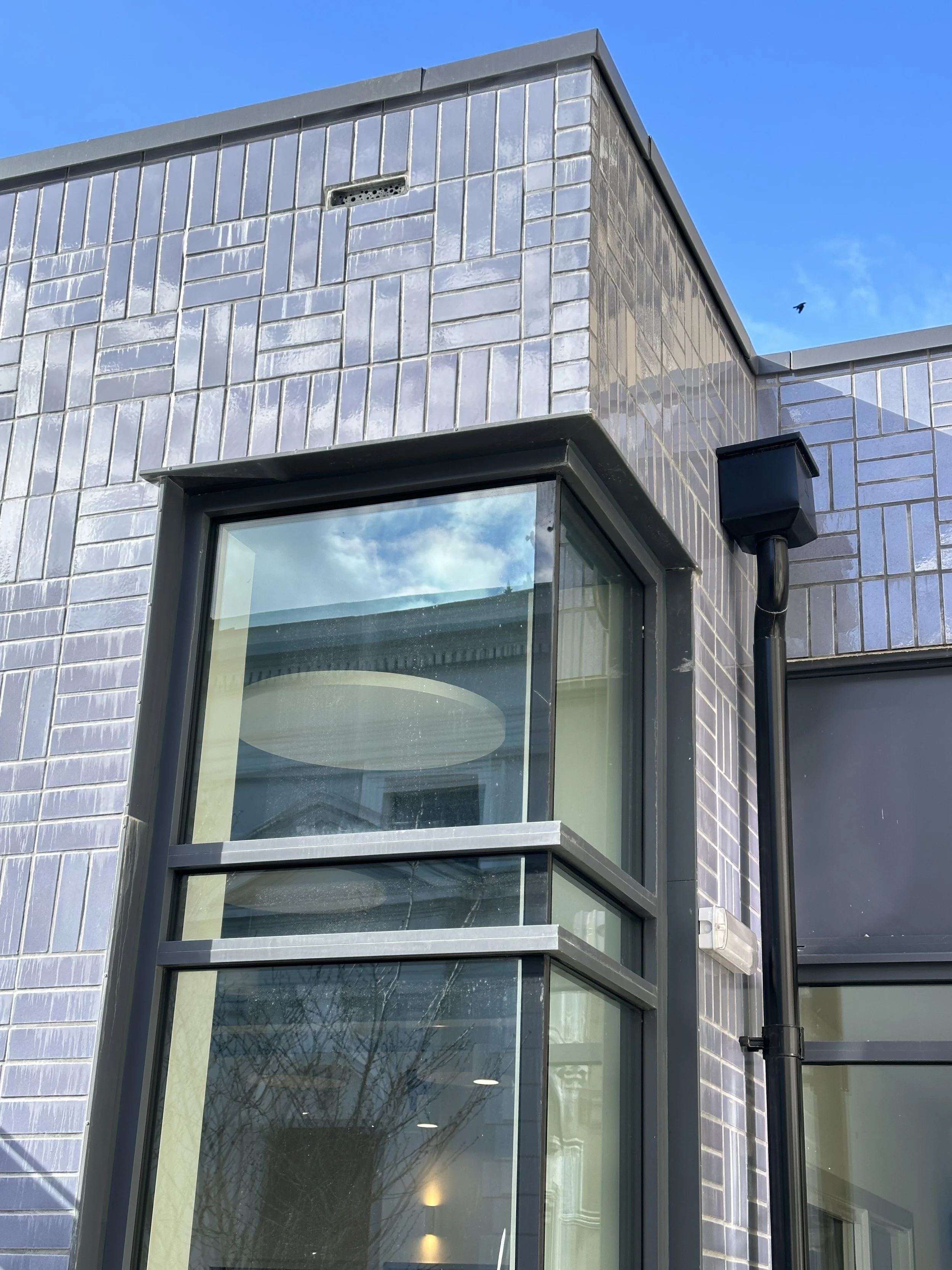 The window detail showing the basket weave tiling